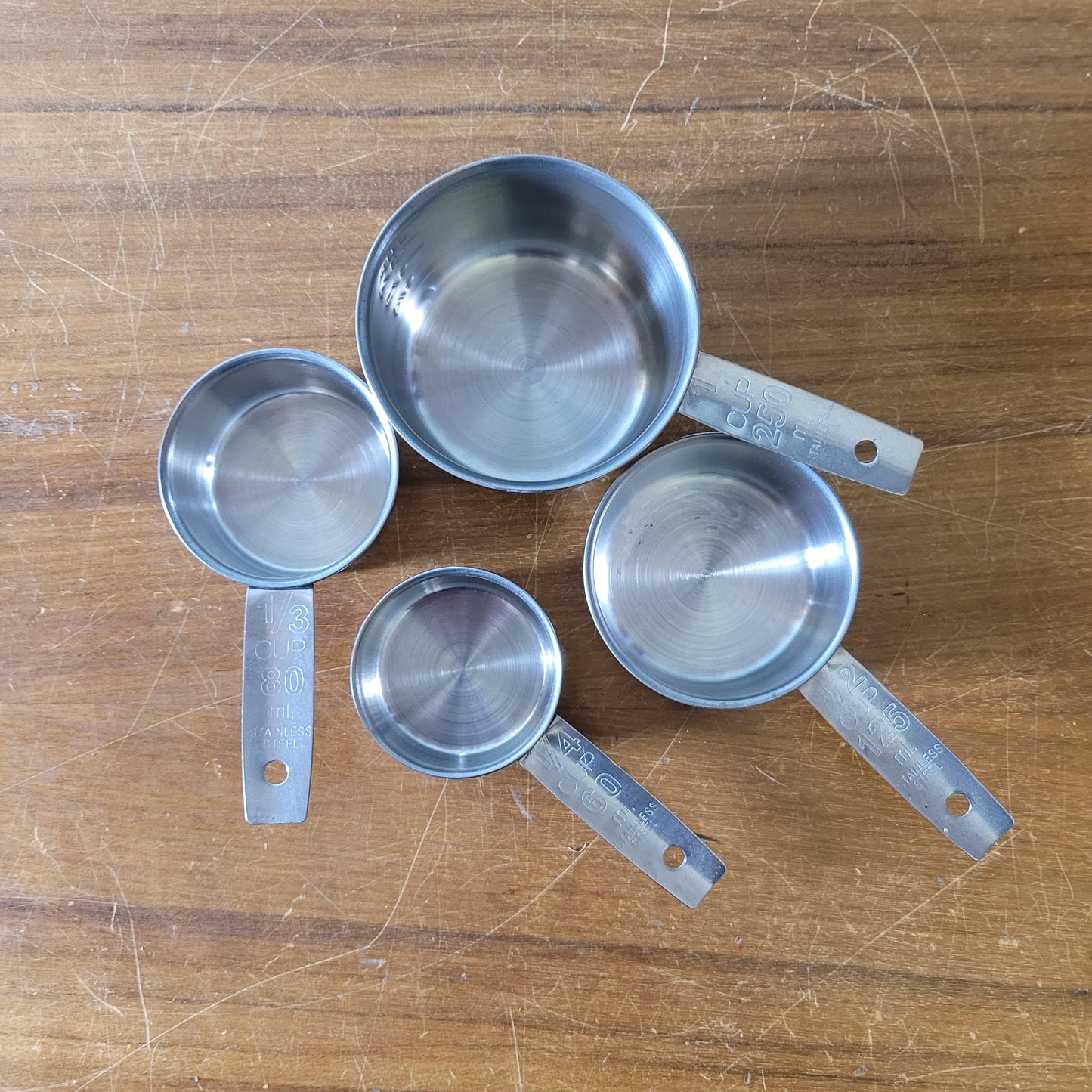 Set of four 1970s stainless steel measuring cups