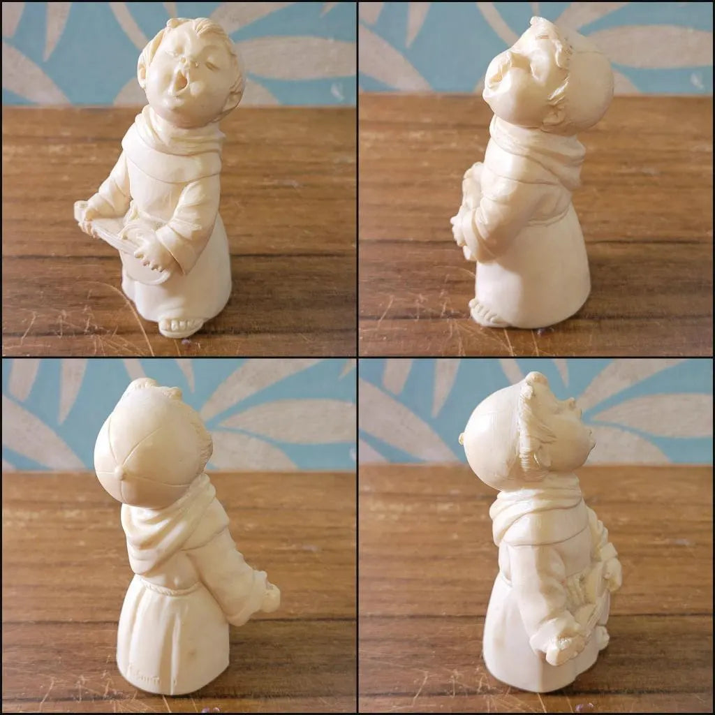 Pair of 1960s/70s ivory-coloured resin singing monk figurines, signed A. Santini