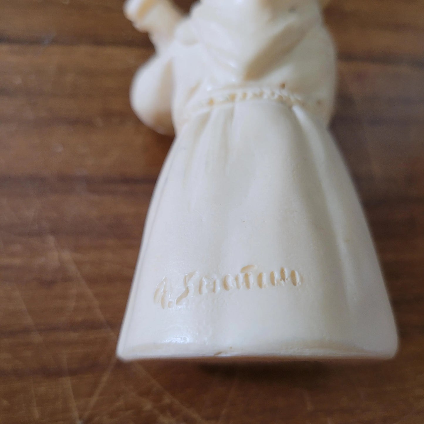 Pair of 1960s/70s ivory-coloured resin singing monk figurines, signed A. Santini