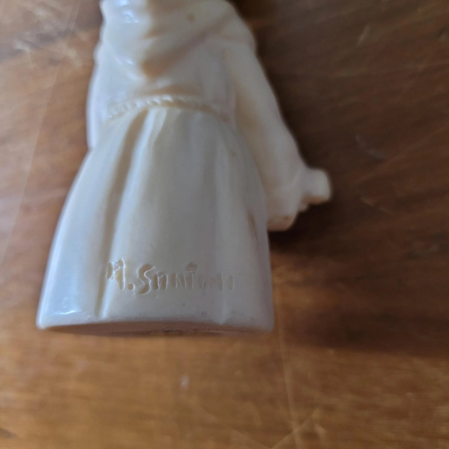 Pair of 1960s/70s ivory-coloured resin singing monk figurines, signed A. Santini