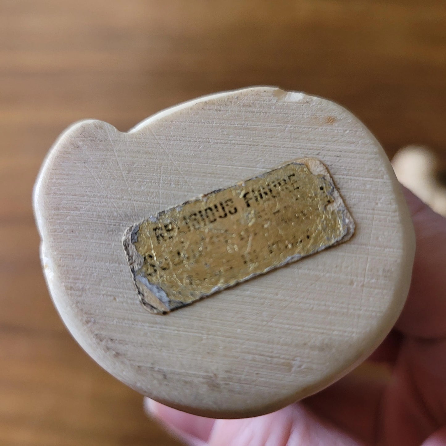 Pair of 1960s/70s ivory-coloured resin singing monk figurines, signed A. Santini