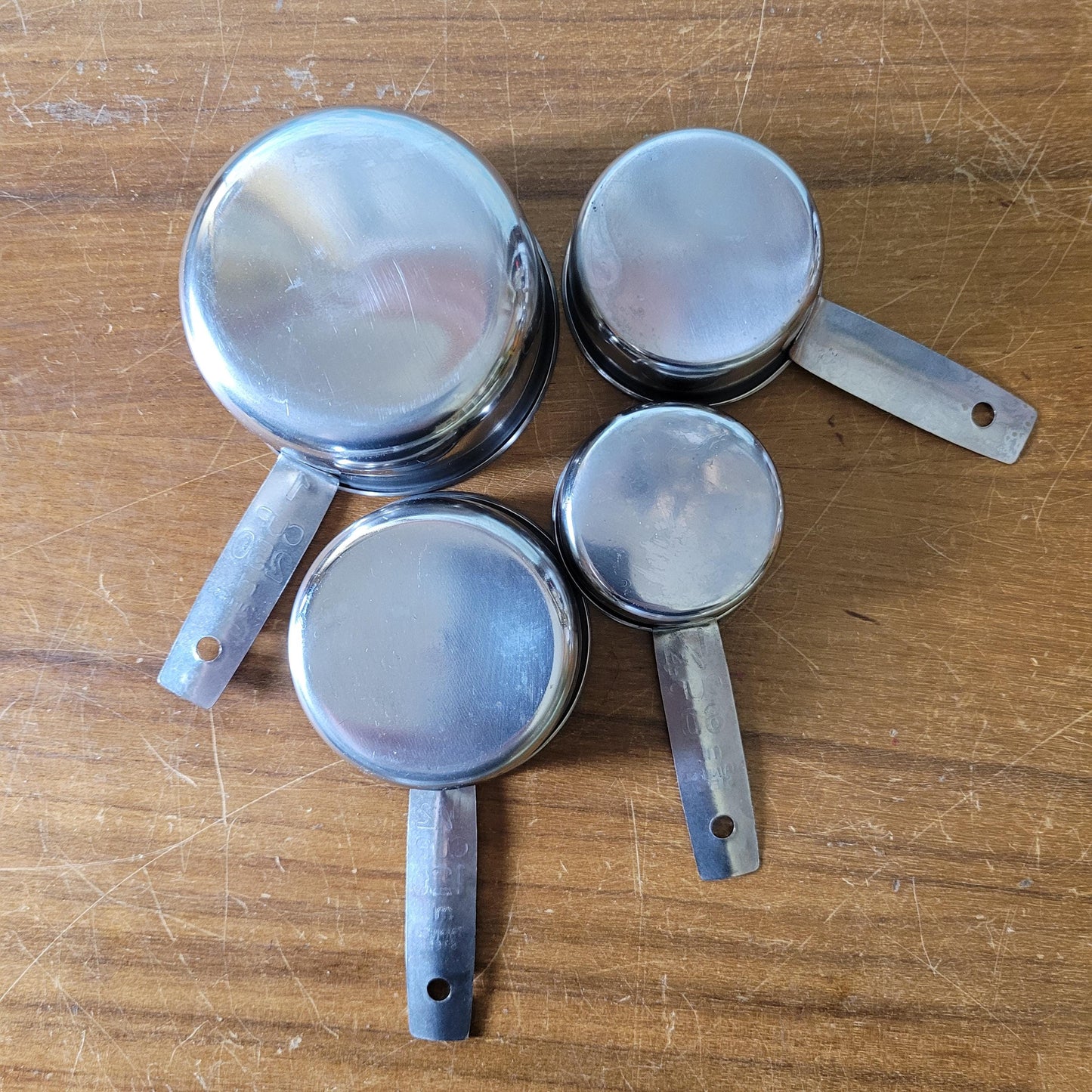 Set of four 1970s stainless steel measuring cups