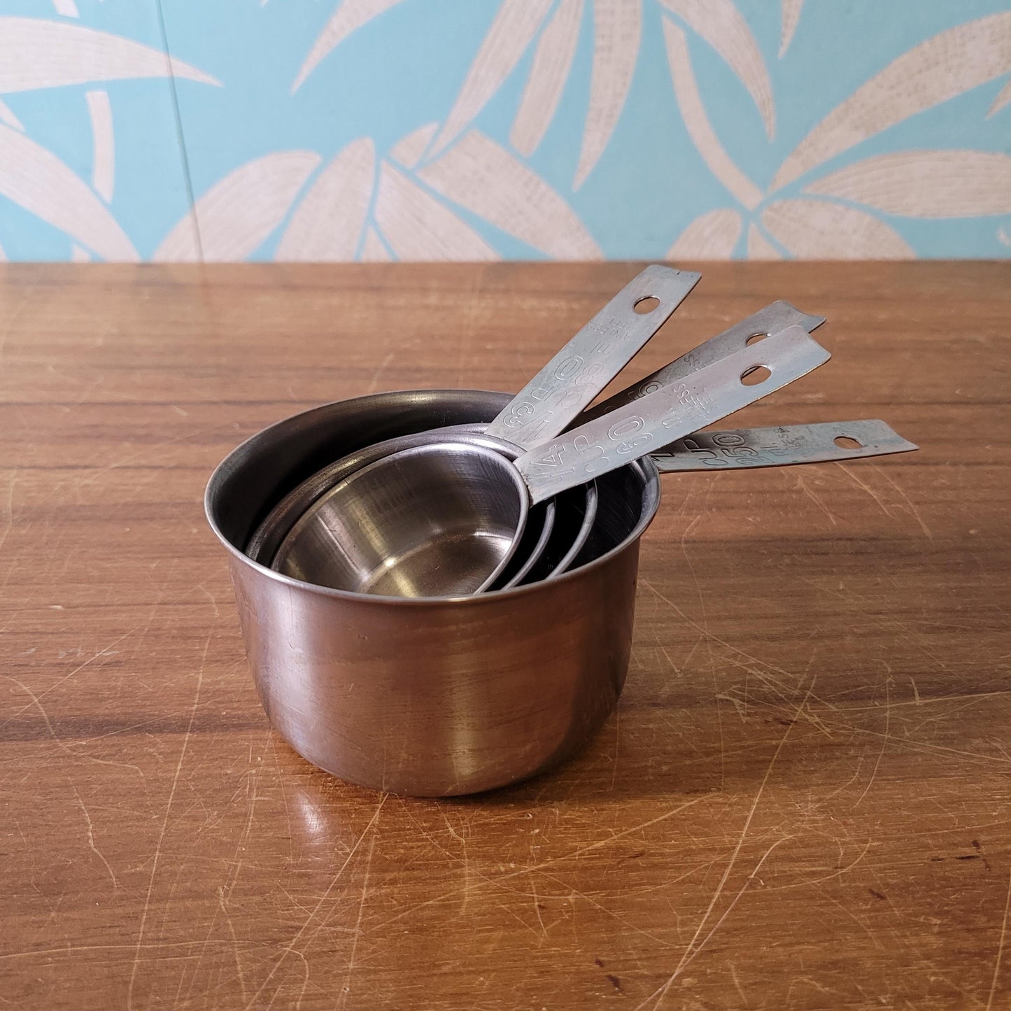 Set of four 1970s stainless steel measuring cups