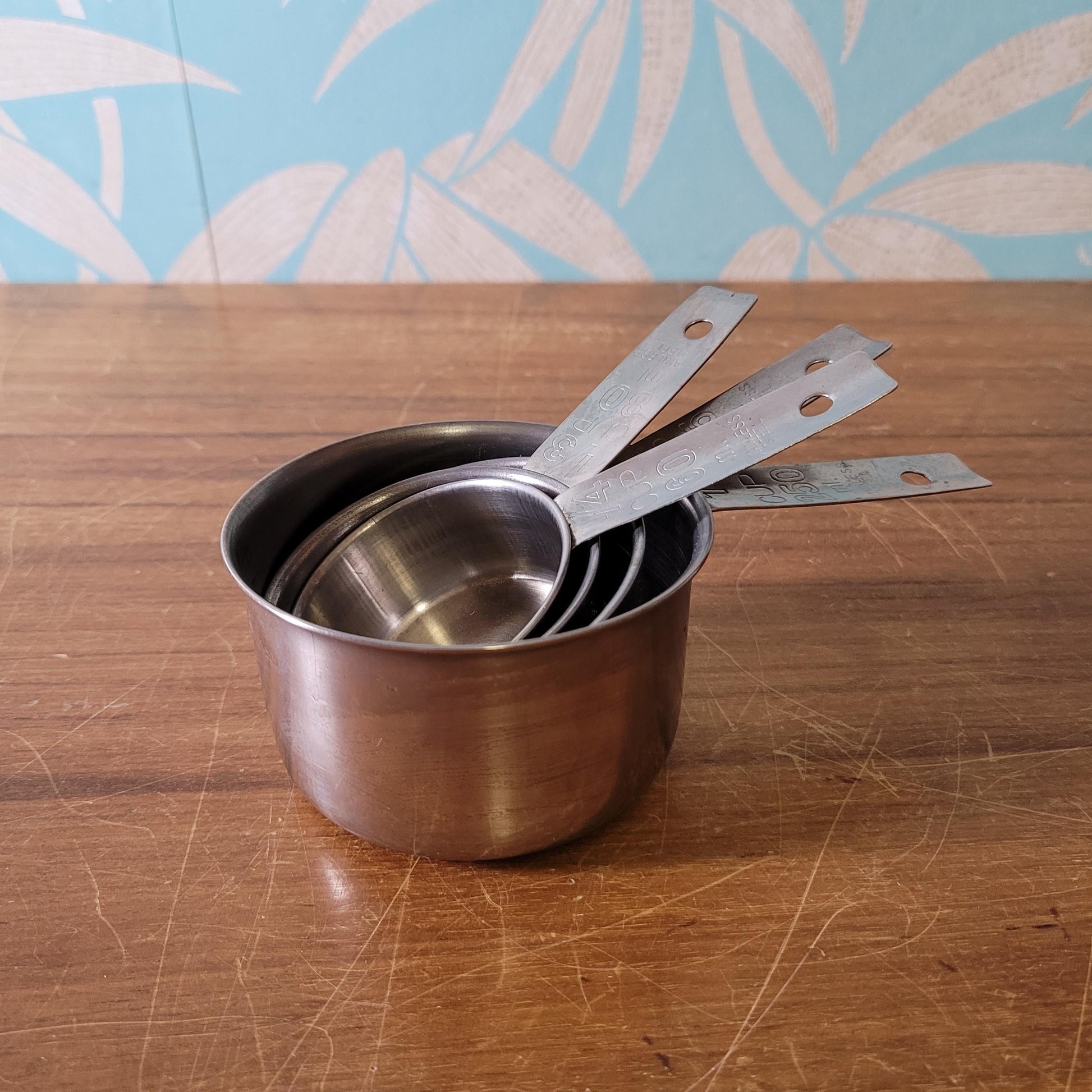 Set of four 1970s stainless steel measuring cups