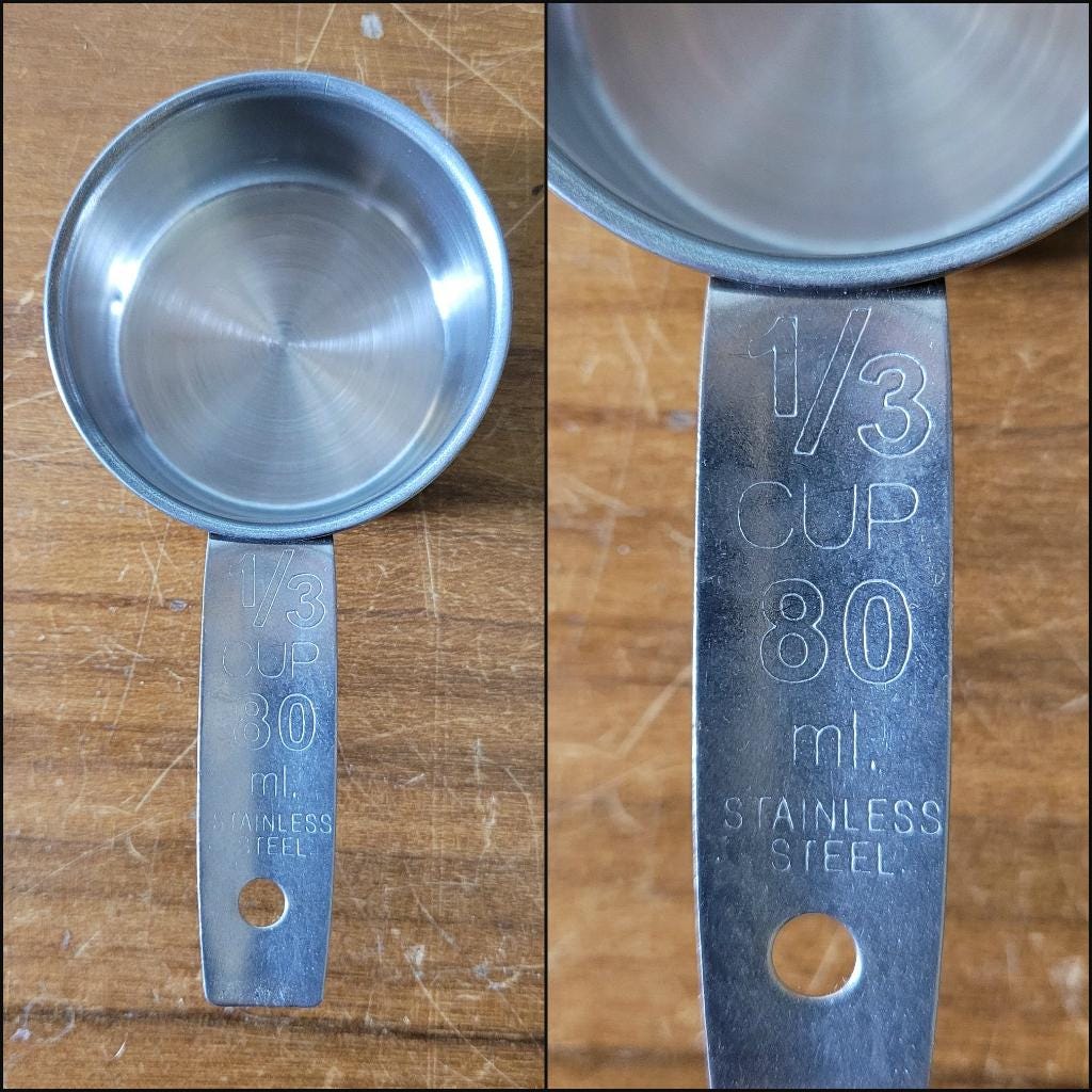Set of four 1970s stainless steel measuring cups