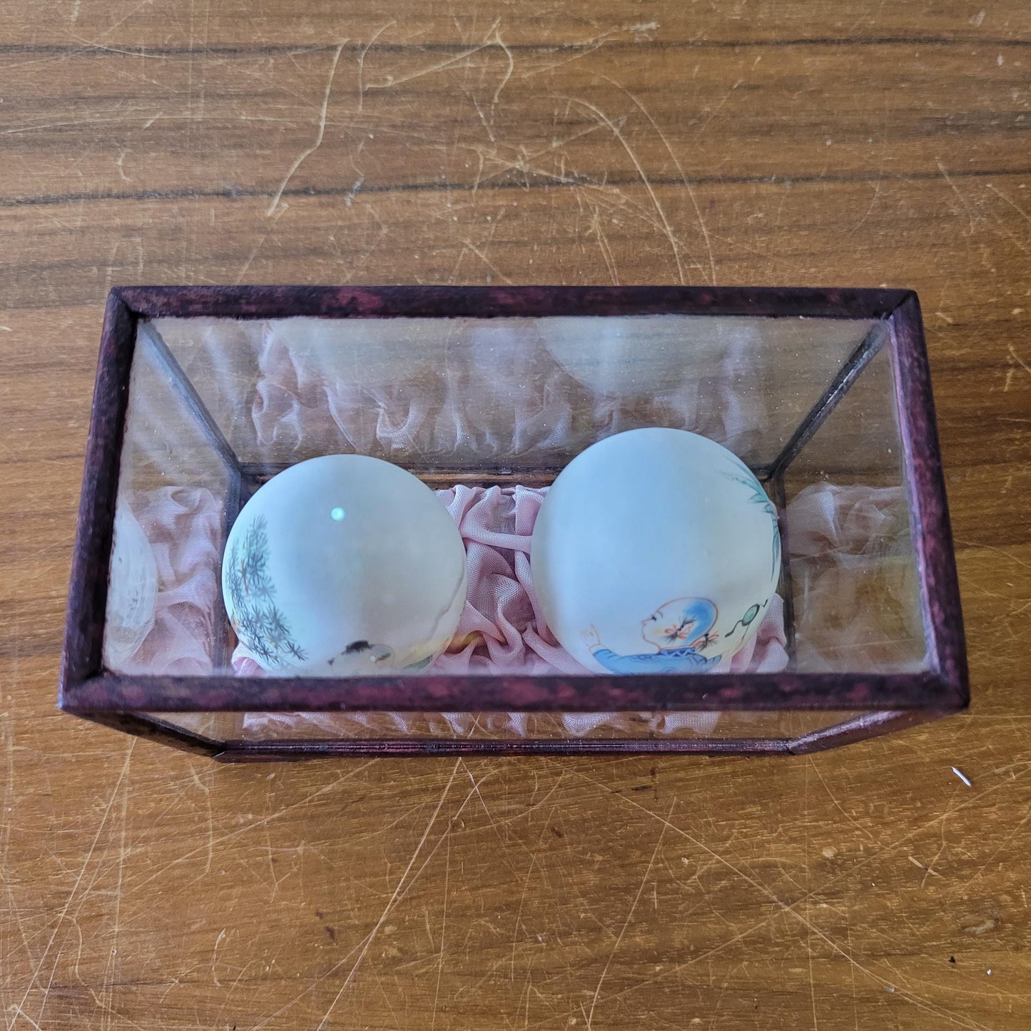 Pair of vintage Chinese hand-painted eggshells in glass display case, children playing