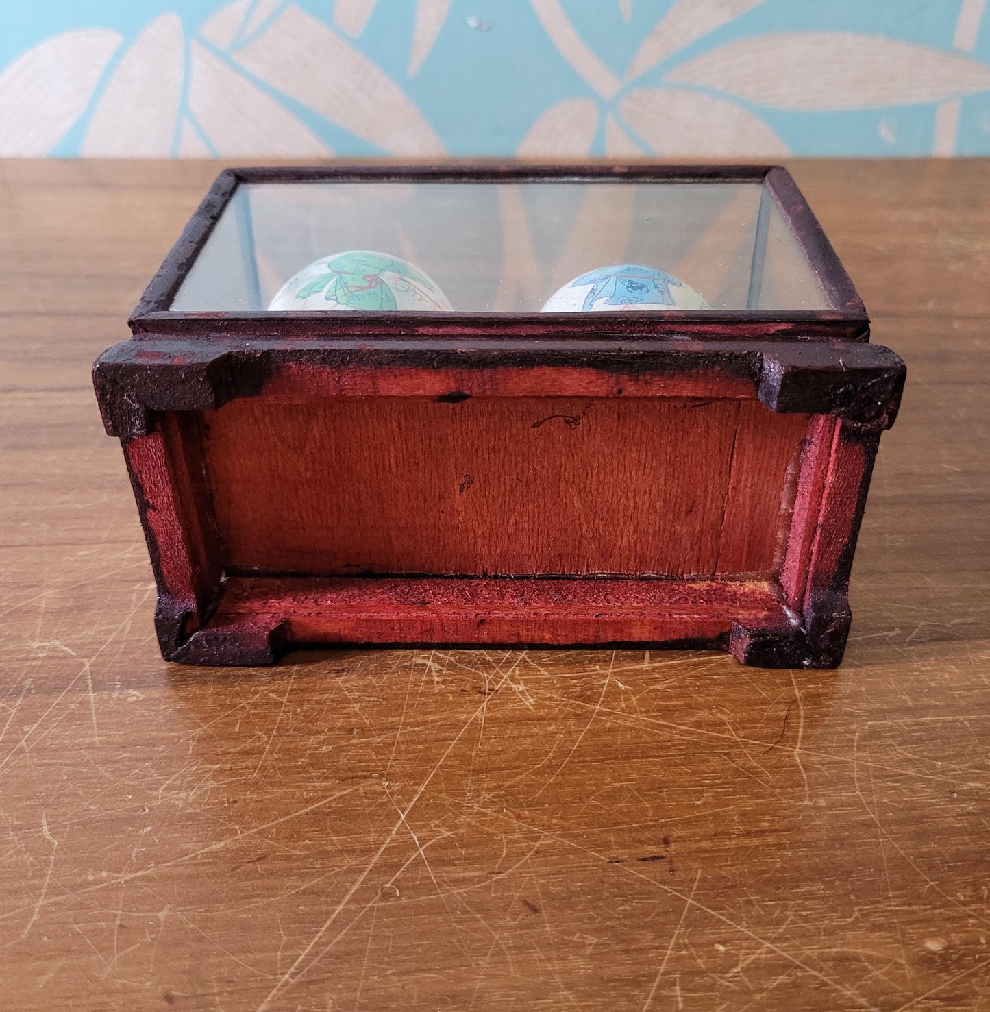 Pair of vintage Chinese hand-painted eggshells in glass display case, children playing