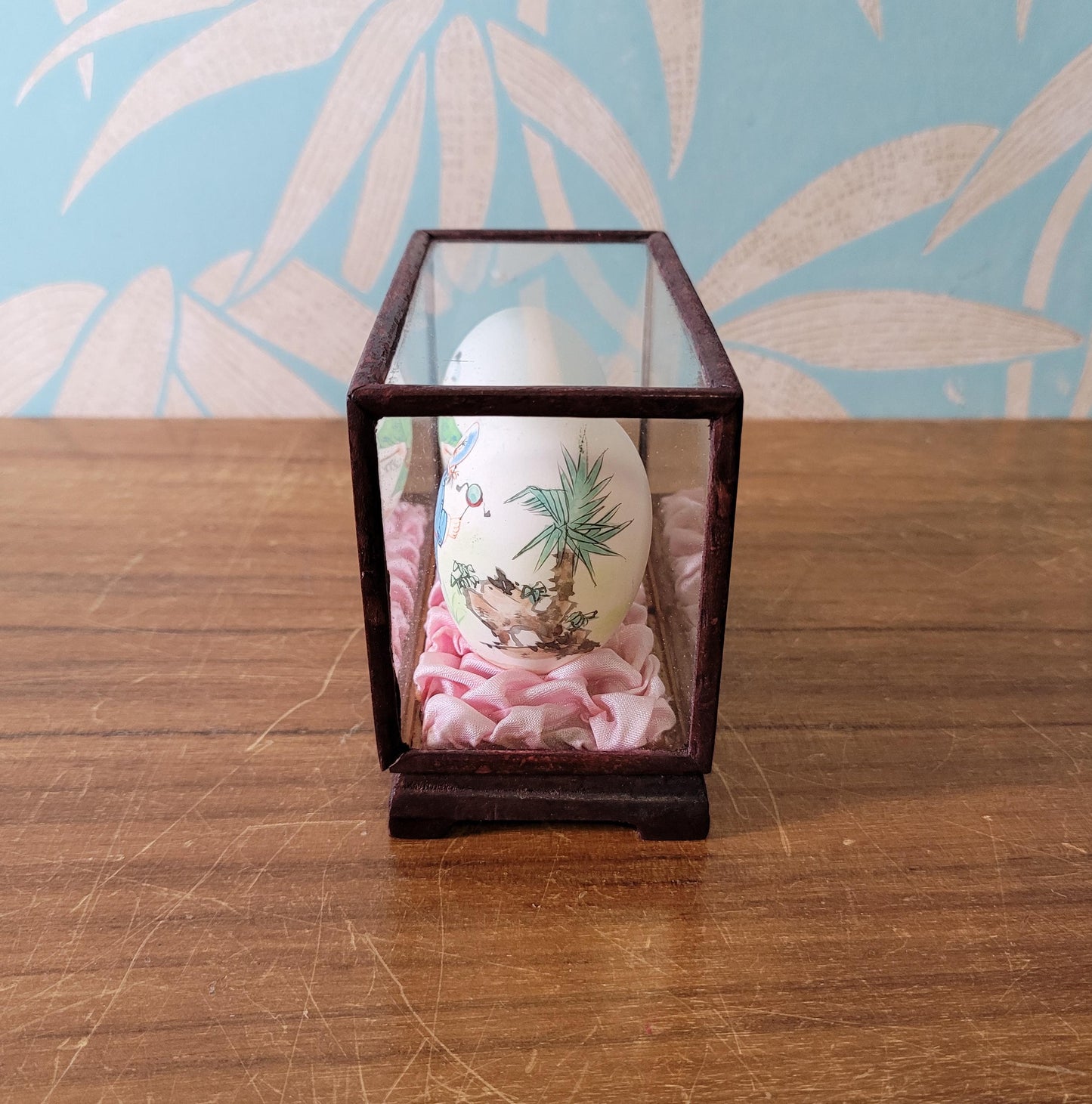 Pair of vintage Chinese hand-painted eggshells in glass display case, children playing
