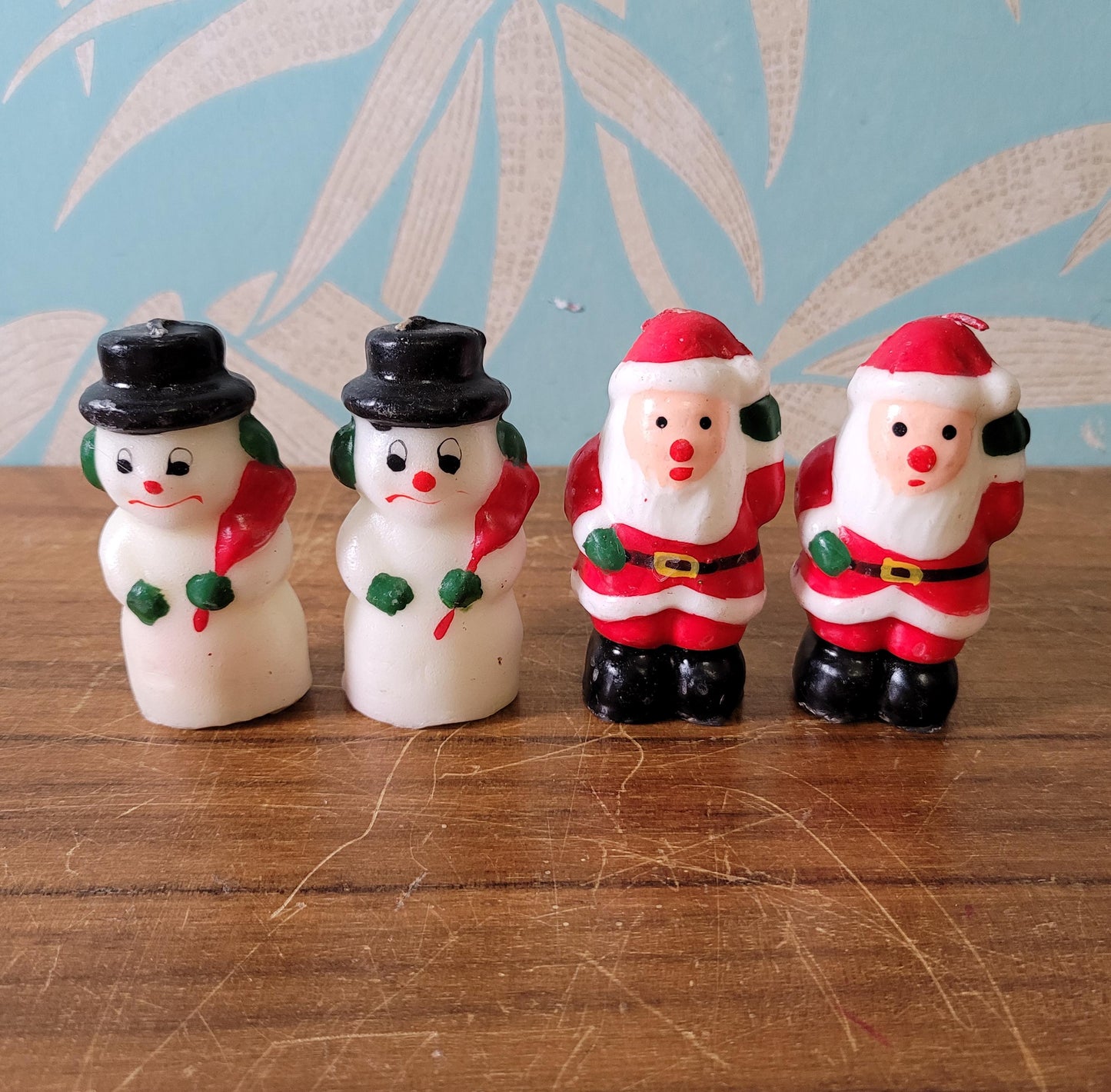 Four vintage novelty Santa, & Snowman miniature candles