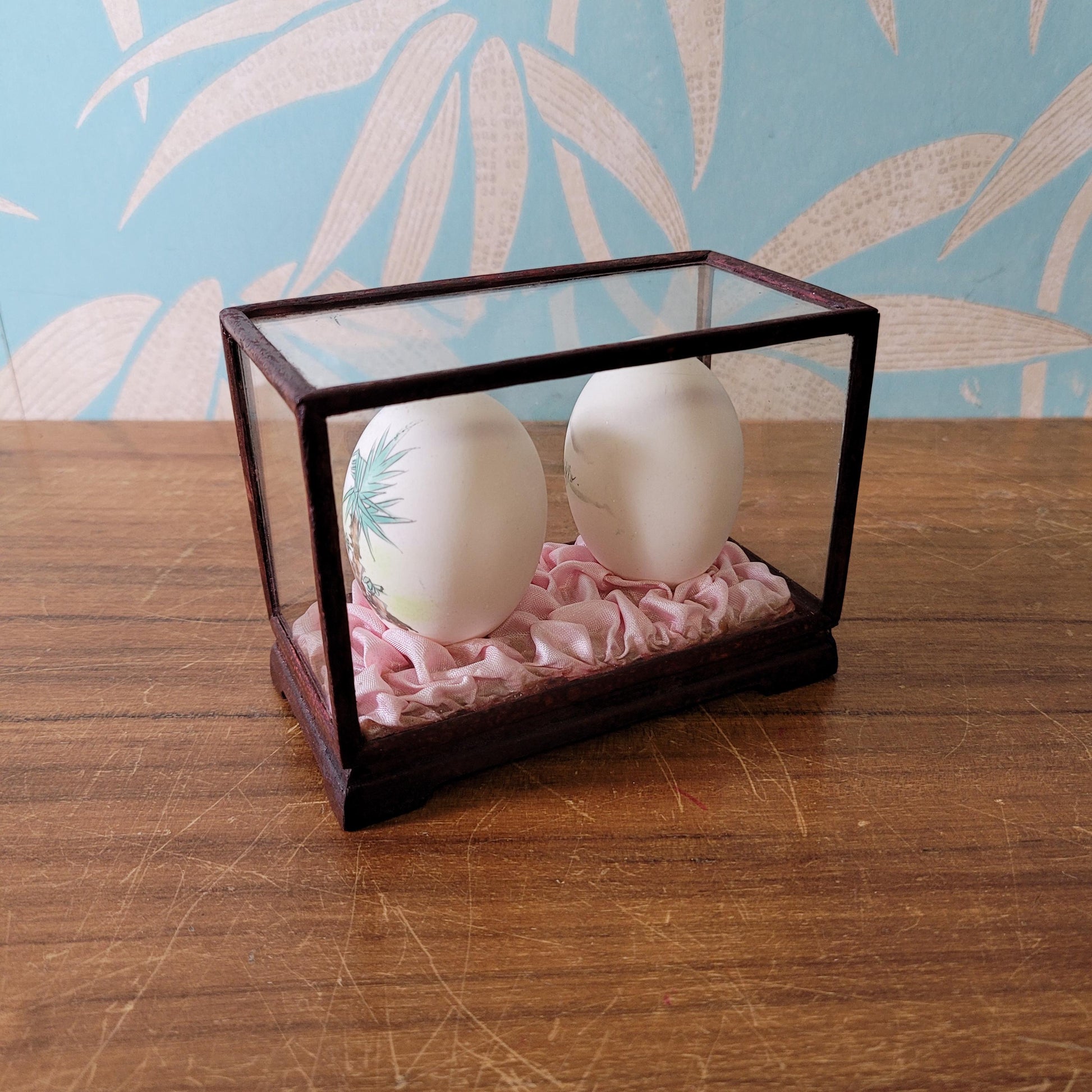 Pair of vintage Chinese hand-painted eggshells in glass display case, children playing