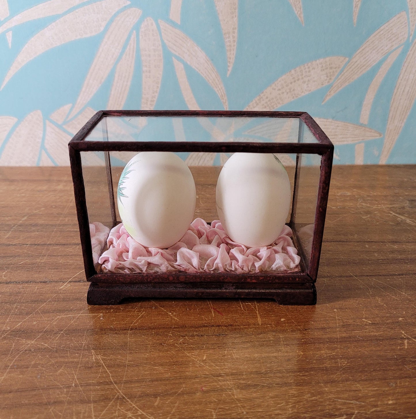 Pair of vintage Chinese hand-painted eggshells in glass display case, children playing