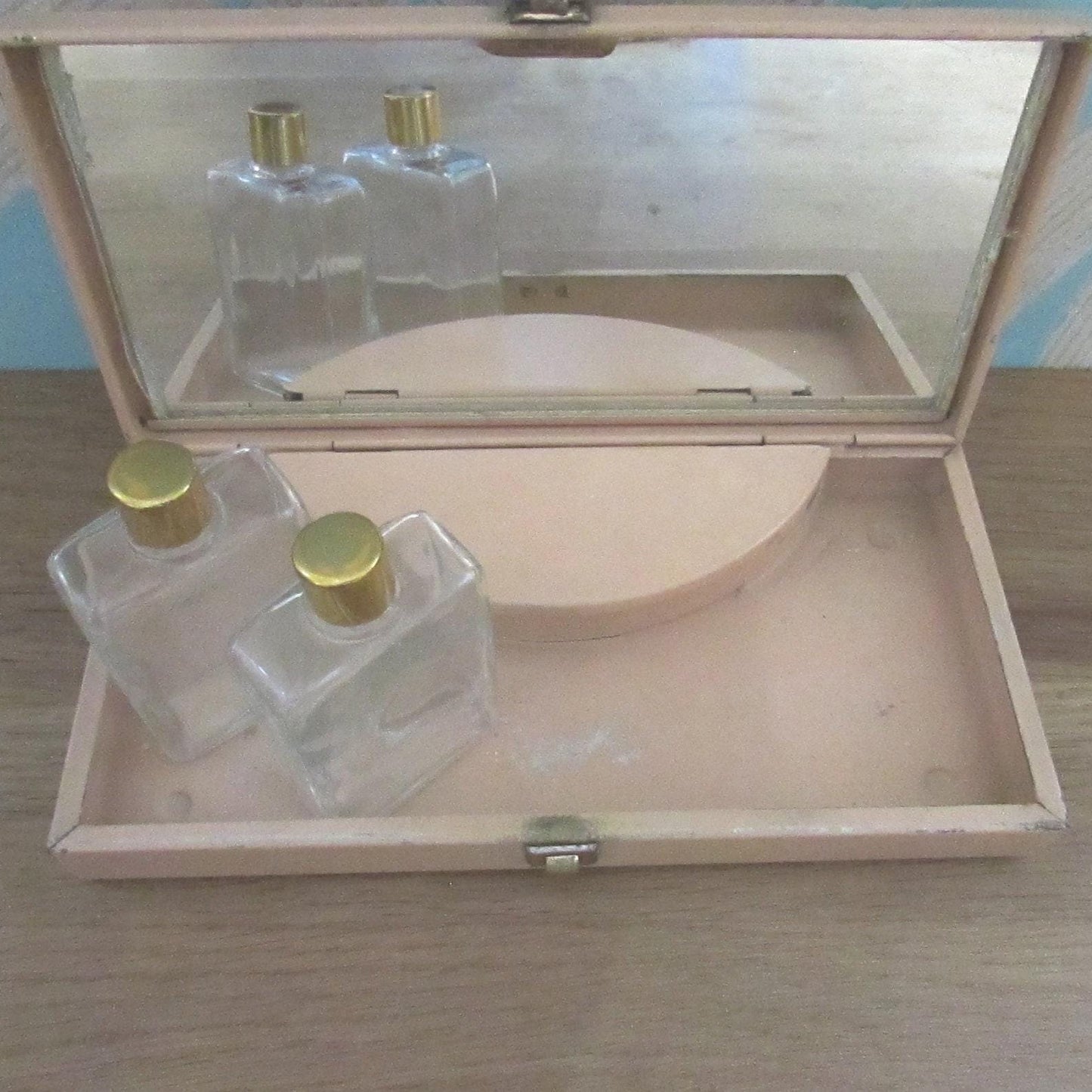 Mid-century travel vanity set in peach-coloured metal case