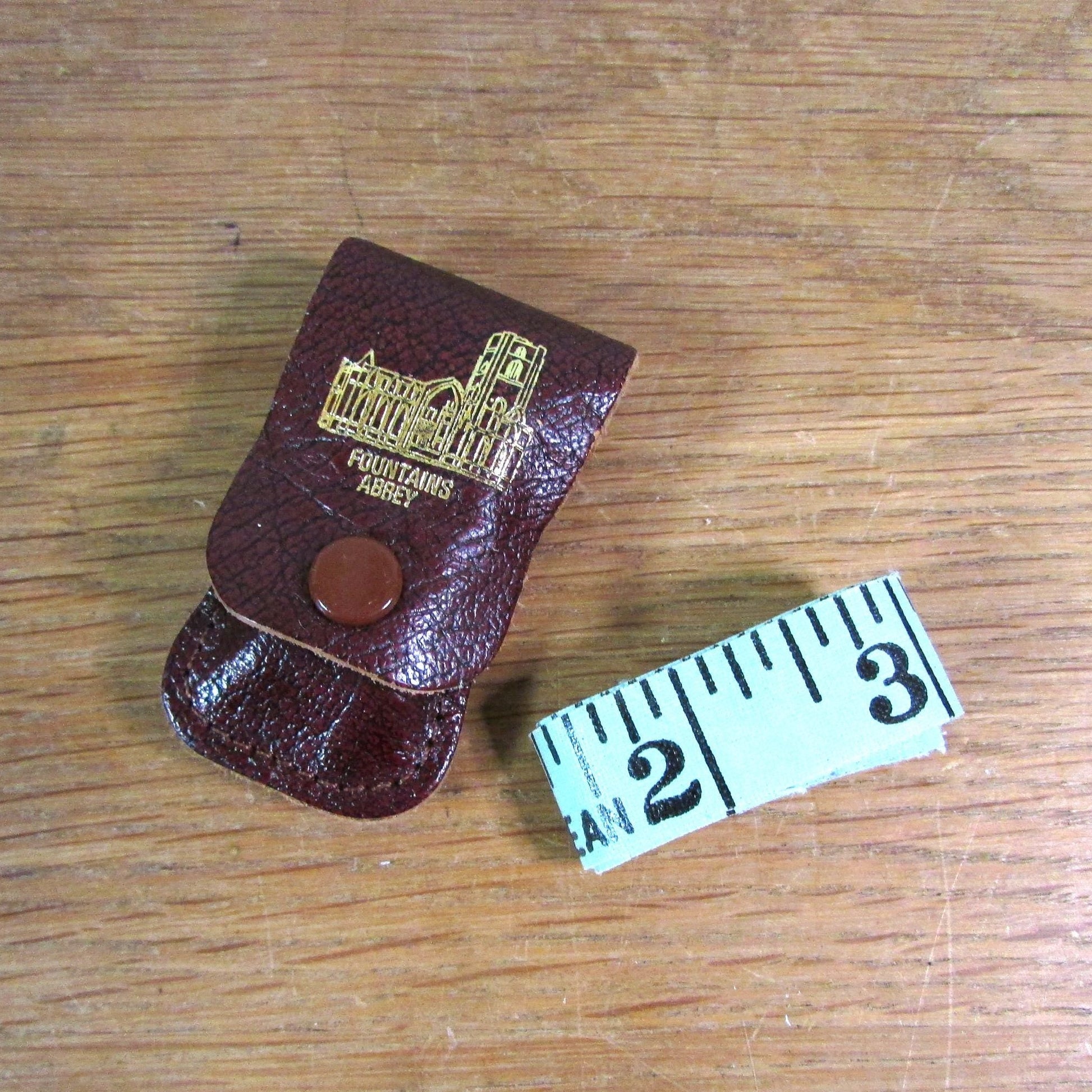 Vintage sewing tape measure in souvenir "Fountains Abbey" leather pouch