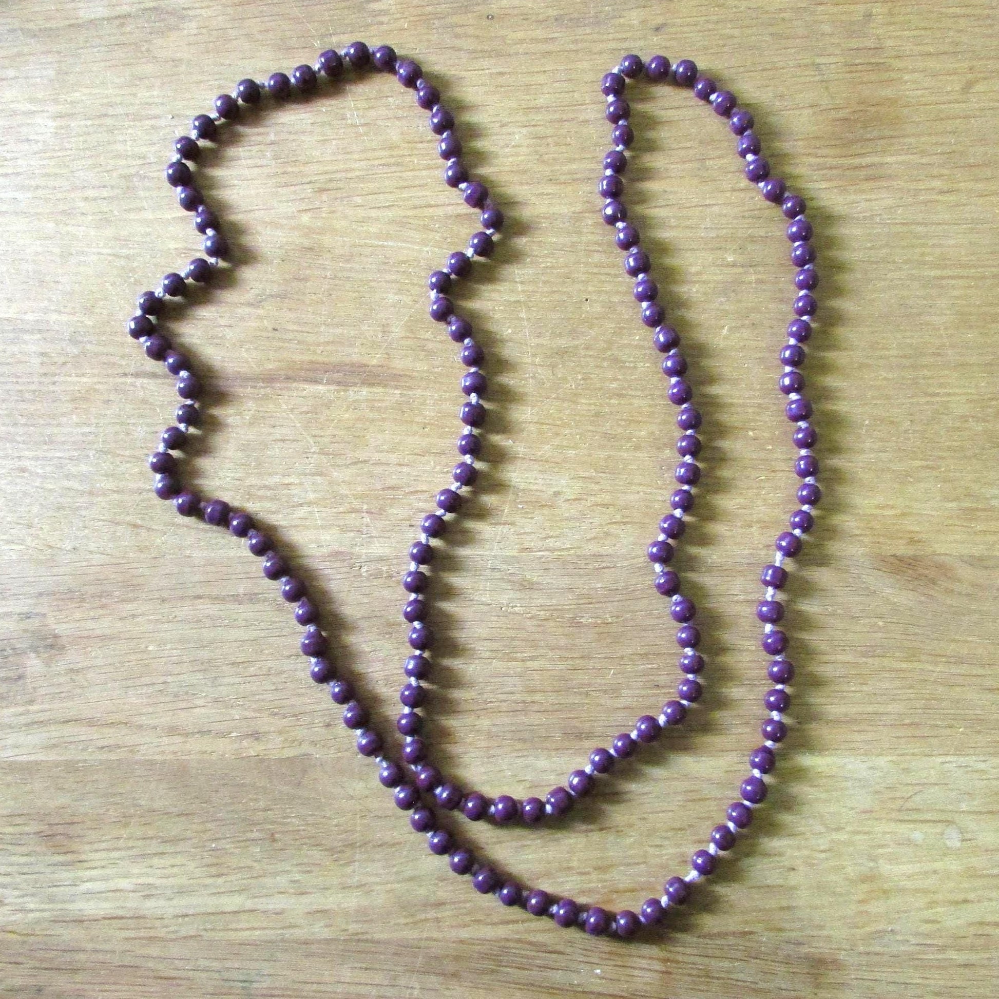 Vintage purple glass bead necklace, beads individually knotted