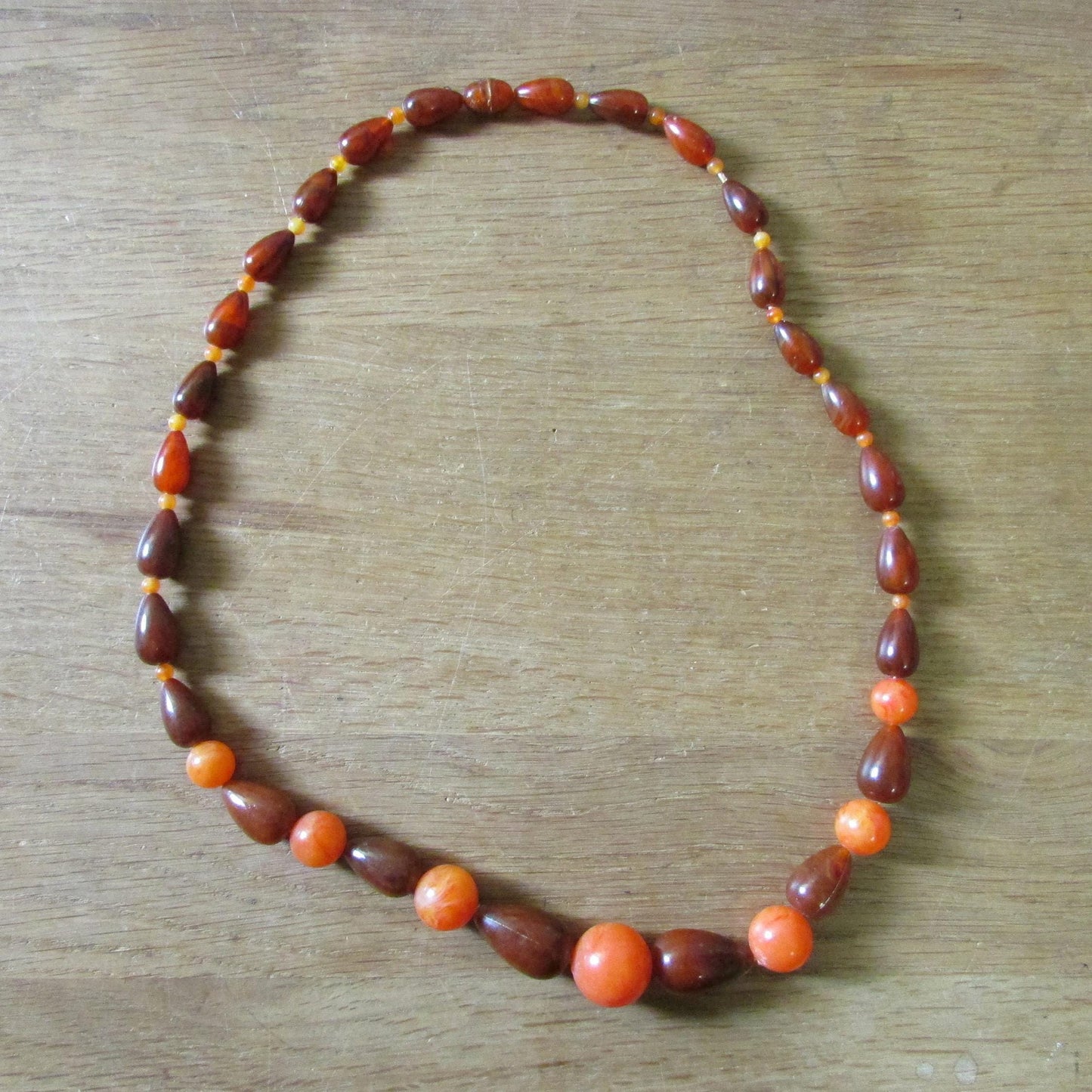 1960s orange & brown marbled plastic teardrop bead necklace with hidden clasp