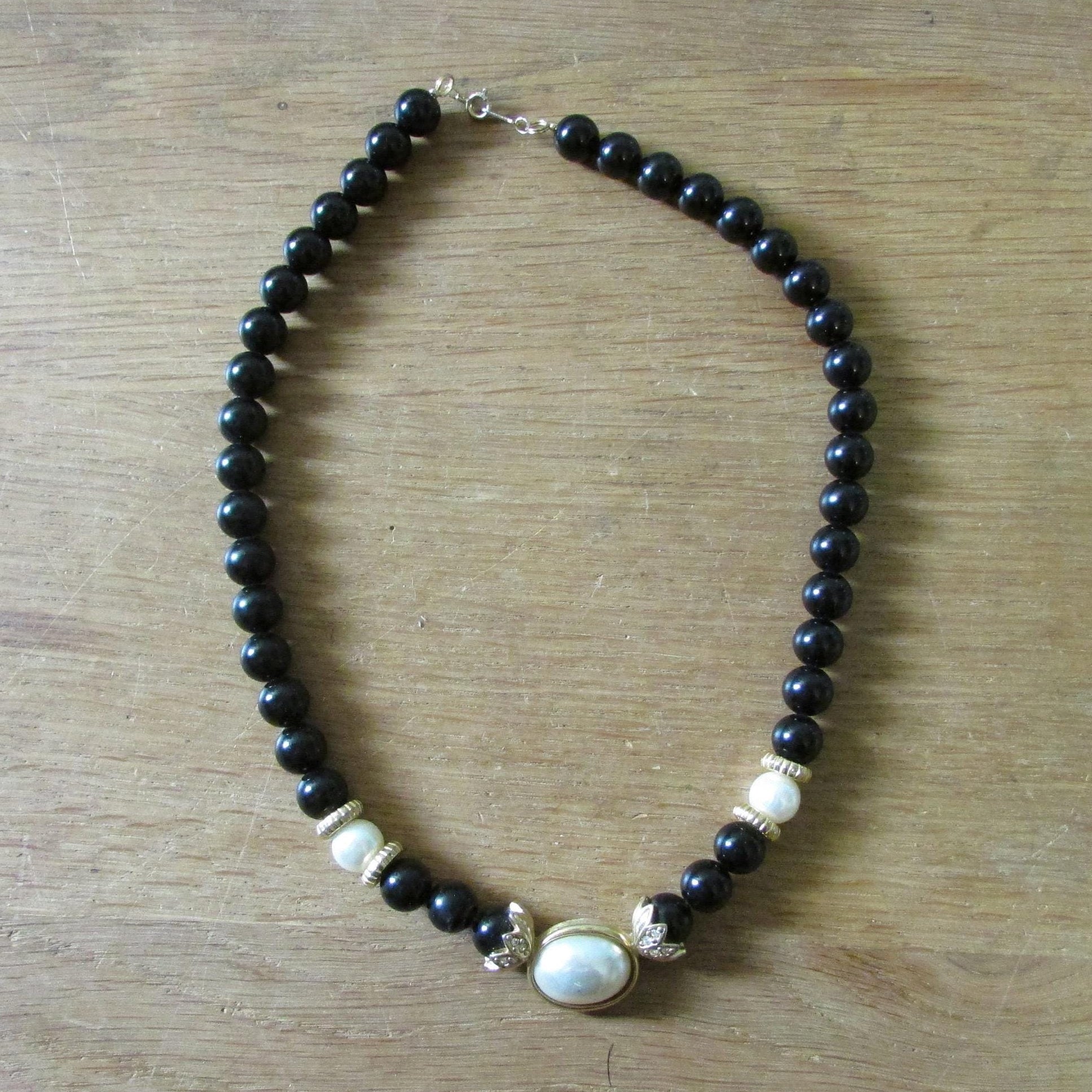 1980s Avon plastic black bead & faux pearl necklace with unusual gold-tone findings