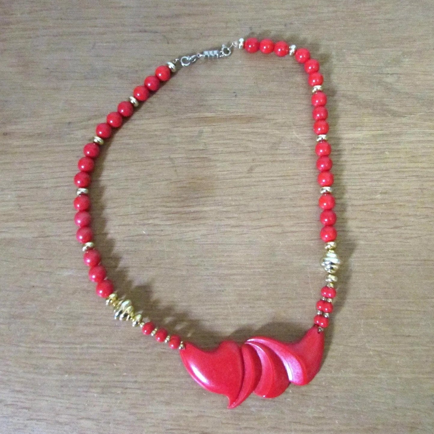 1980s red plastic bead statement necklace with sculptural centrepiece