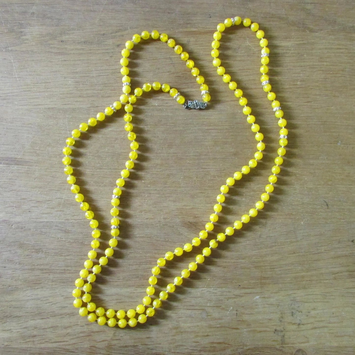 1950s yellow plastic round bead rope necklace with silver-tone spacers
