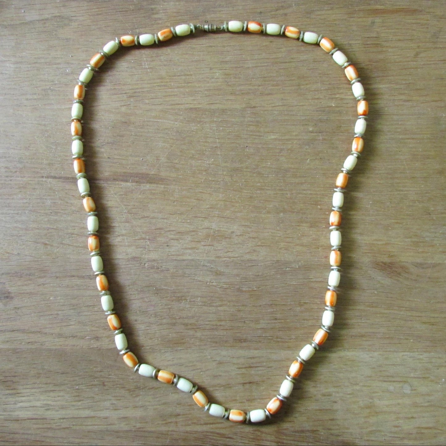 1960s/70s cream & orange marbled resin cylinder bead necklace with gold-tone spacers