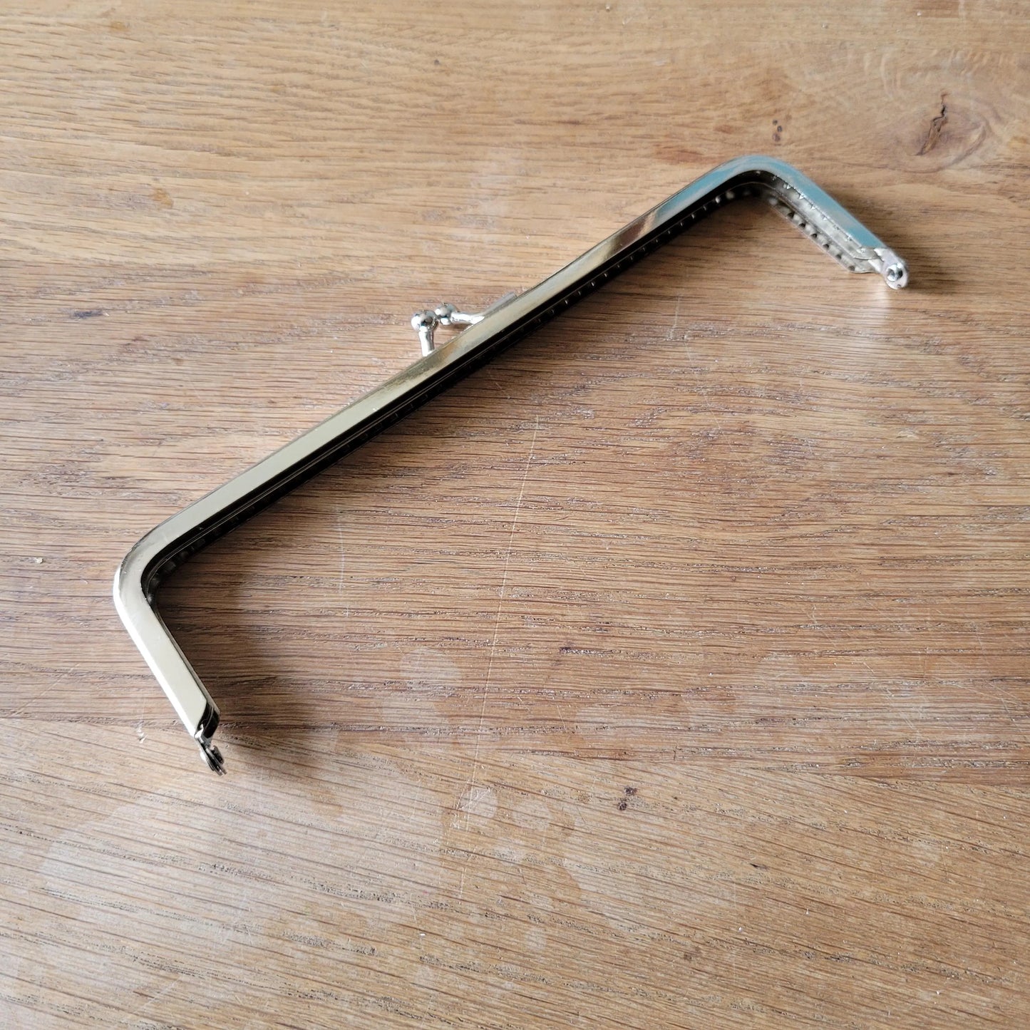 Silver-tone metal purse frame with kiss ball clasp
