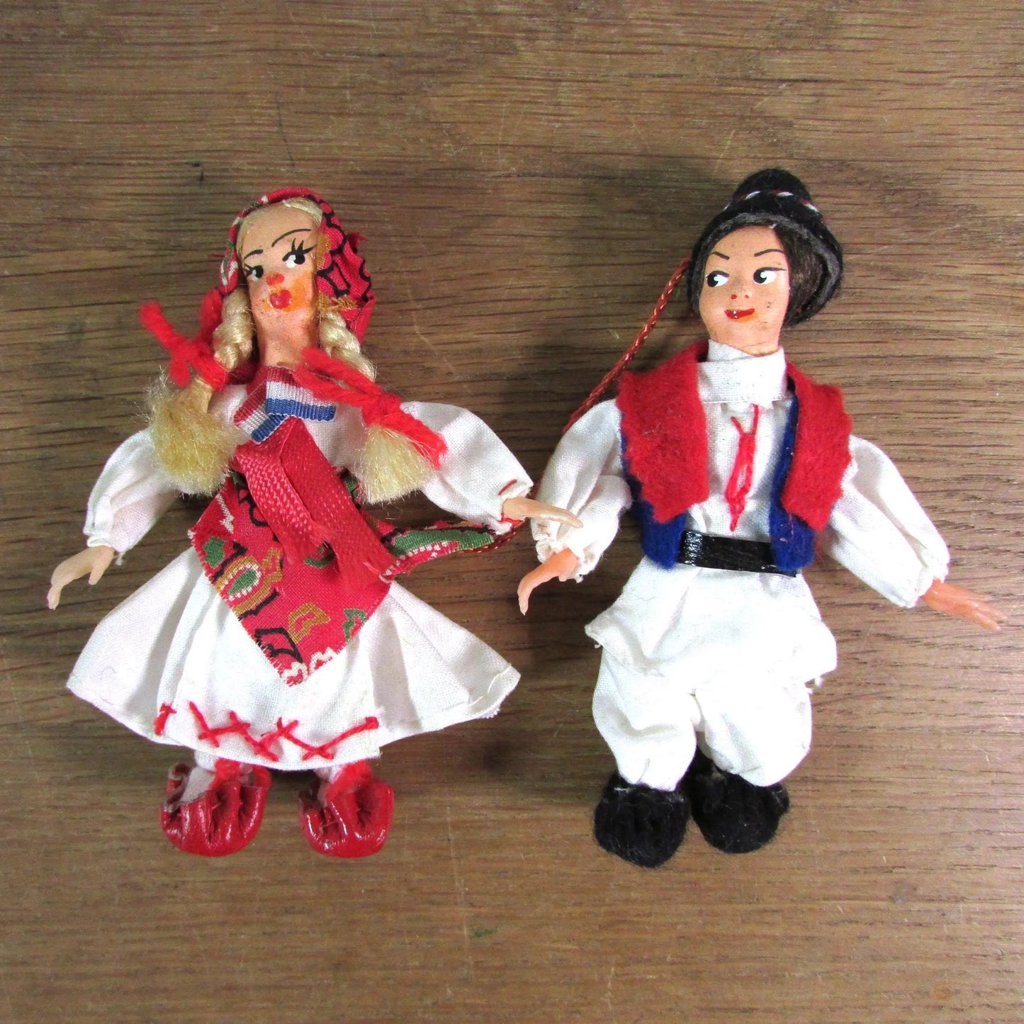 Pair of vintage miniature Yugoslavian souvenir dolls, linked together, in traditional costume