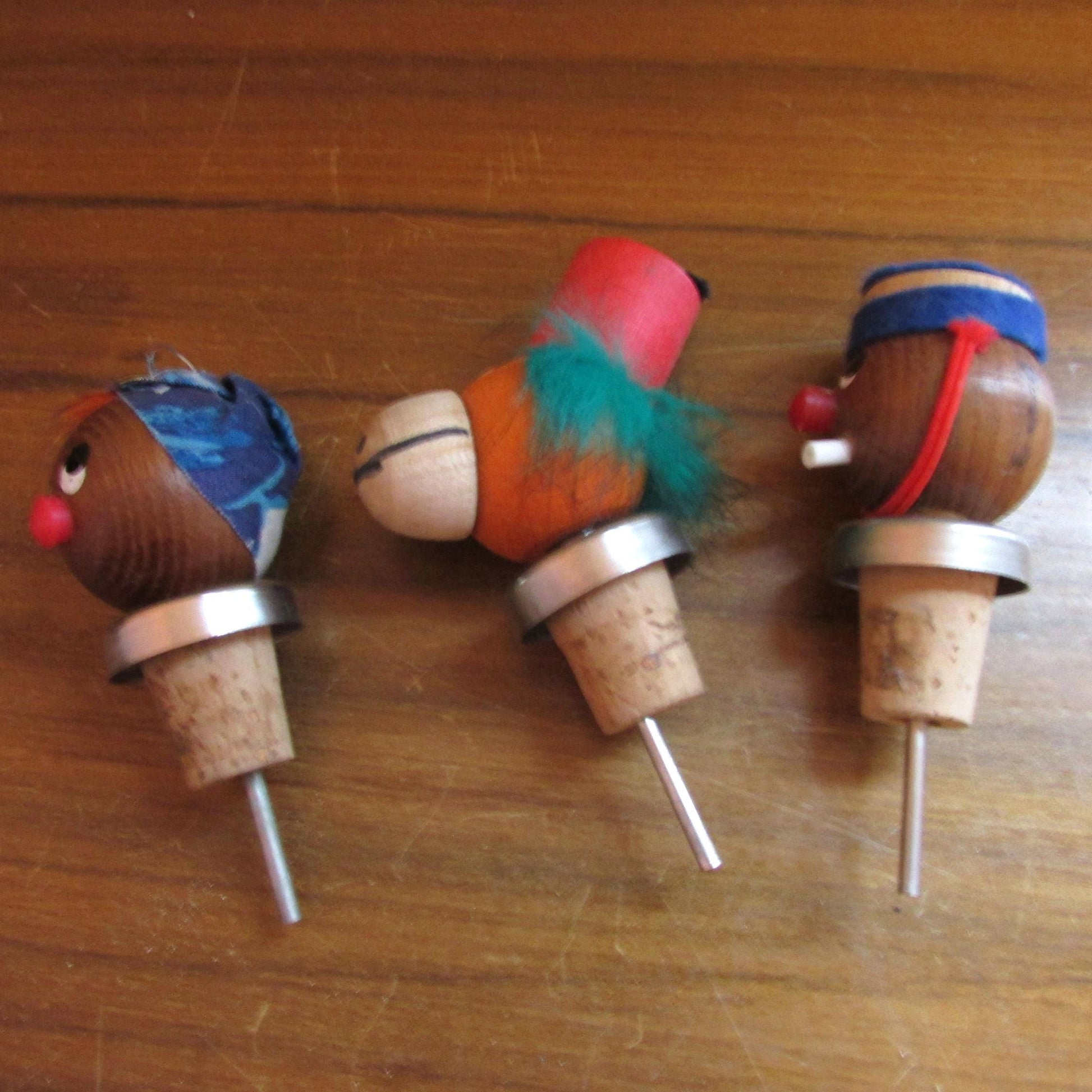 Three 1960s Gonk-style wooden character bottle stoppers/pourouts