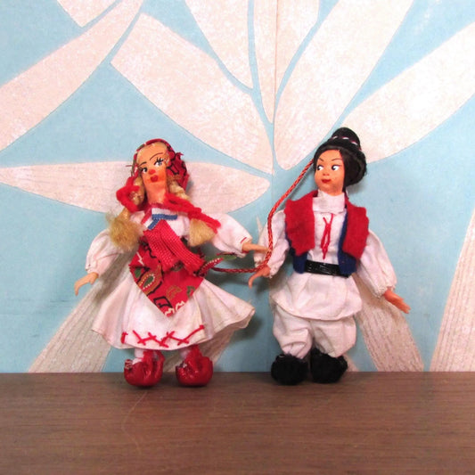 Pair of vintage miniature Yugoslavian souvenir dolls, linked together, in traditional costume