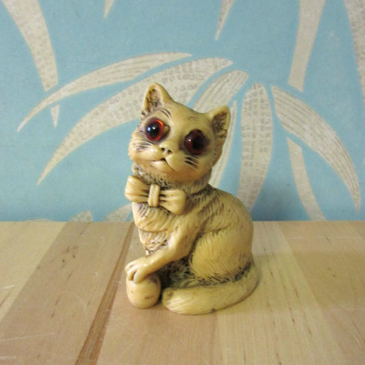 Vintage Norleans ivory resin cat in bow tie figurine with glass eyes