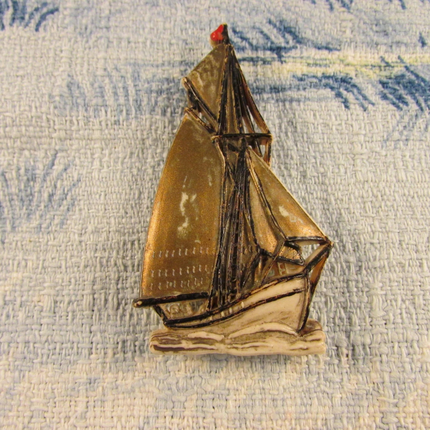 Vintage plastic tall ship brooch, stamped Made in England
