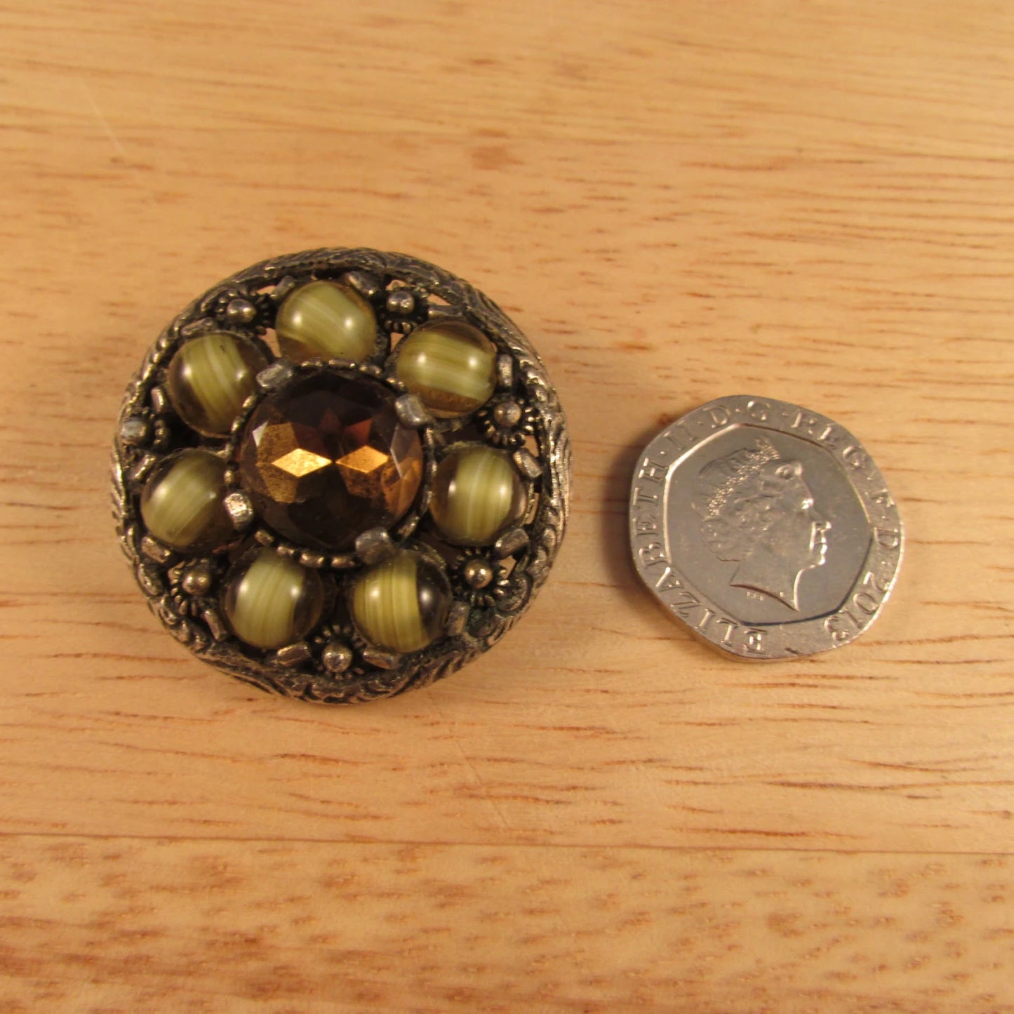 1970s round Celtic-style pendant/brooch, polished green stones with citrine centre, stamped MIRACLE