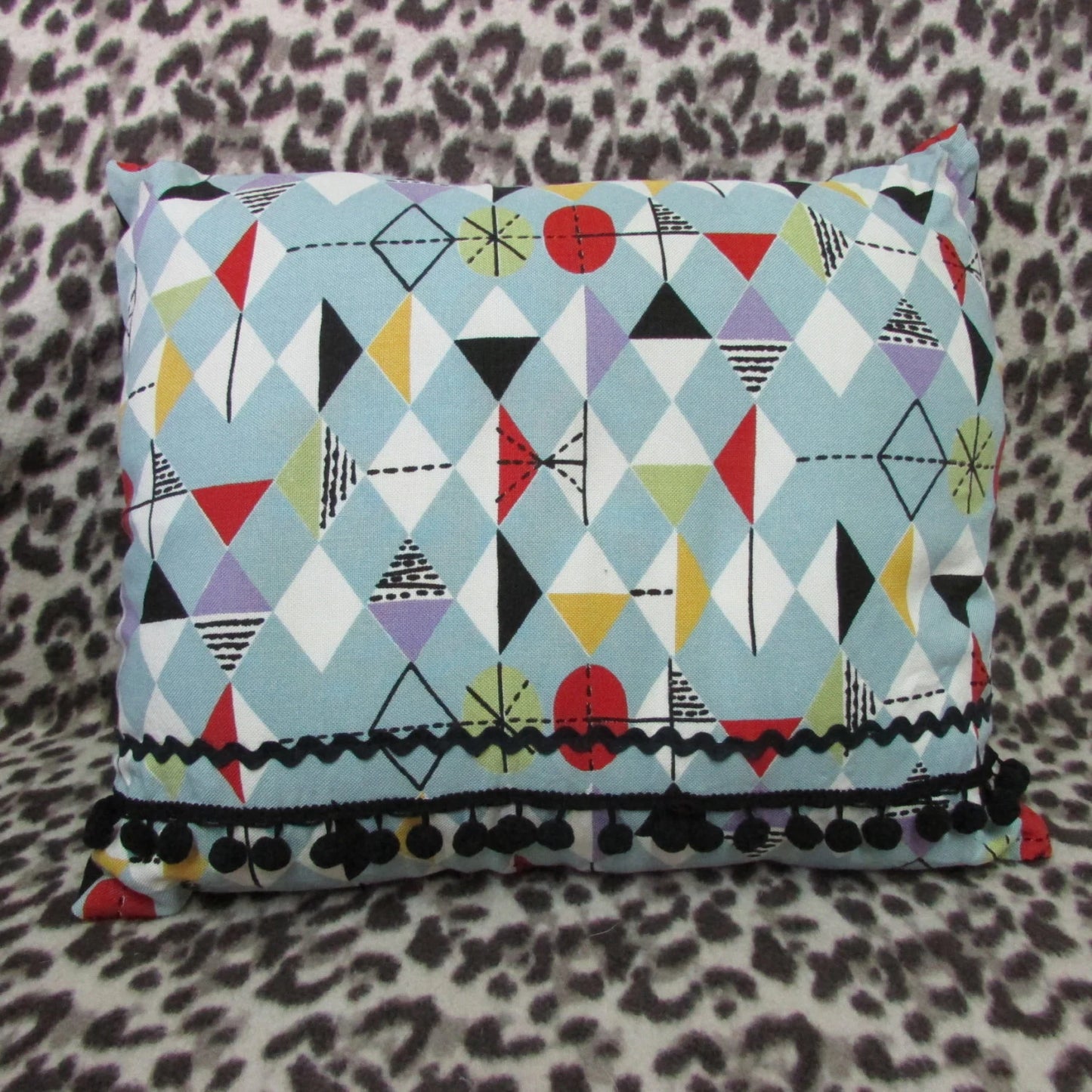 Home-made mid-century Marian Mahler atomic fabric cushion, black ric-rac, & pompom trim, and contrast black reverse
