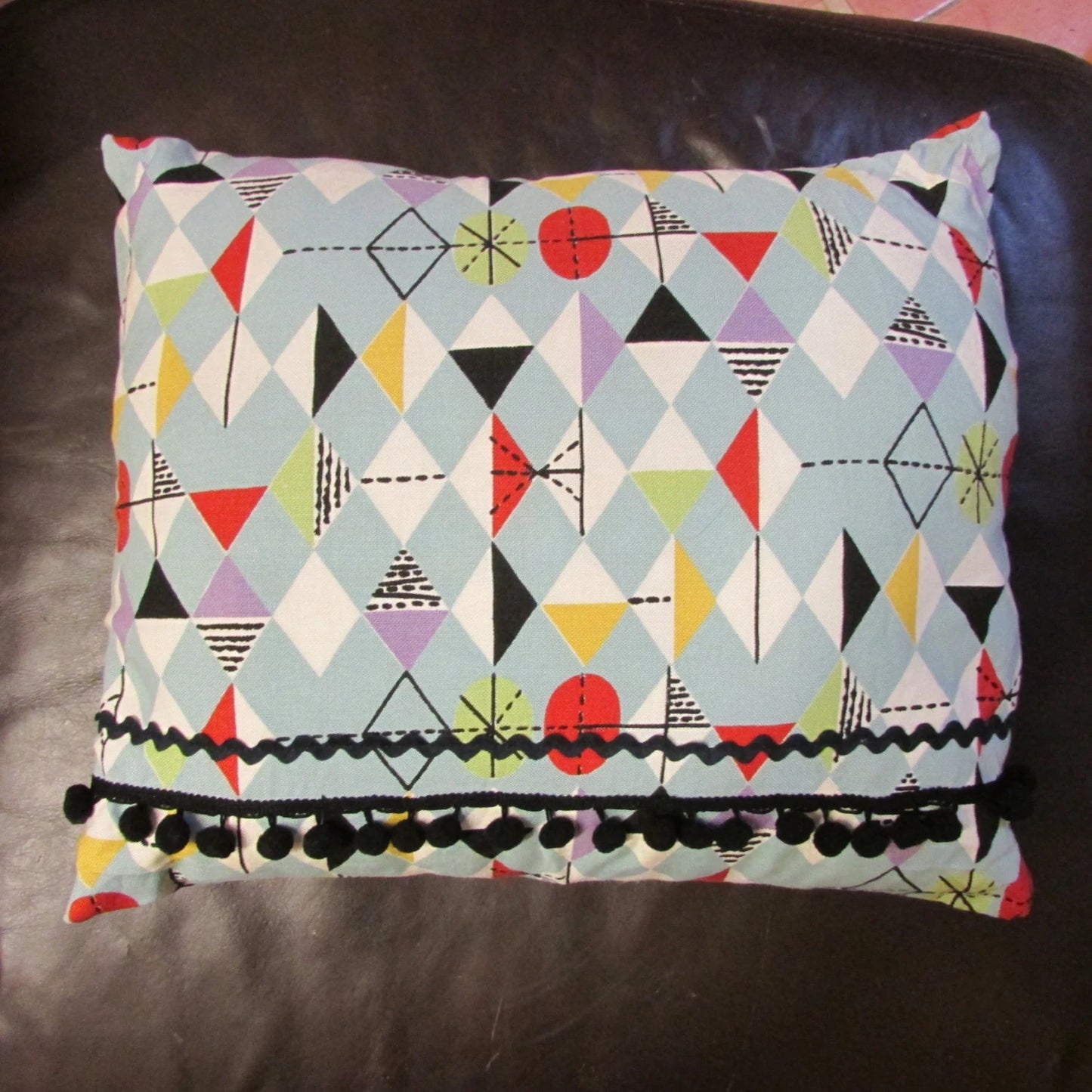 Home-made mid-century Marian Mahler atomic fabric cushion, black ric-rac, & pompom trim, and contrast black reverse