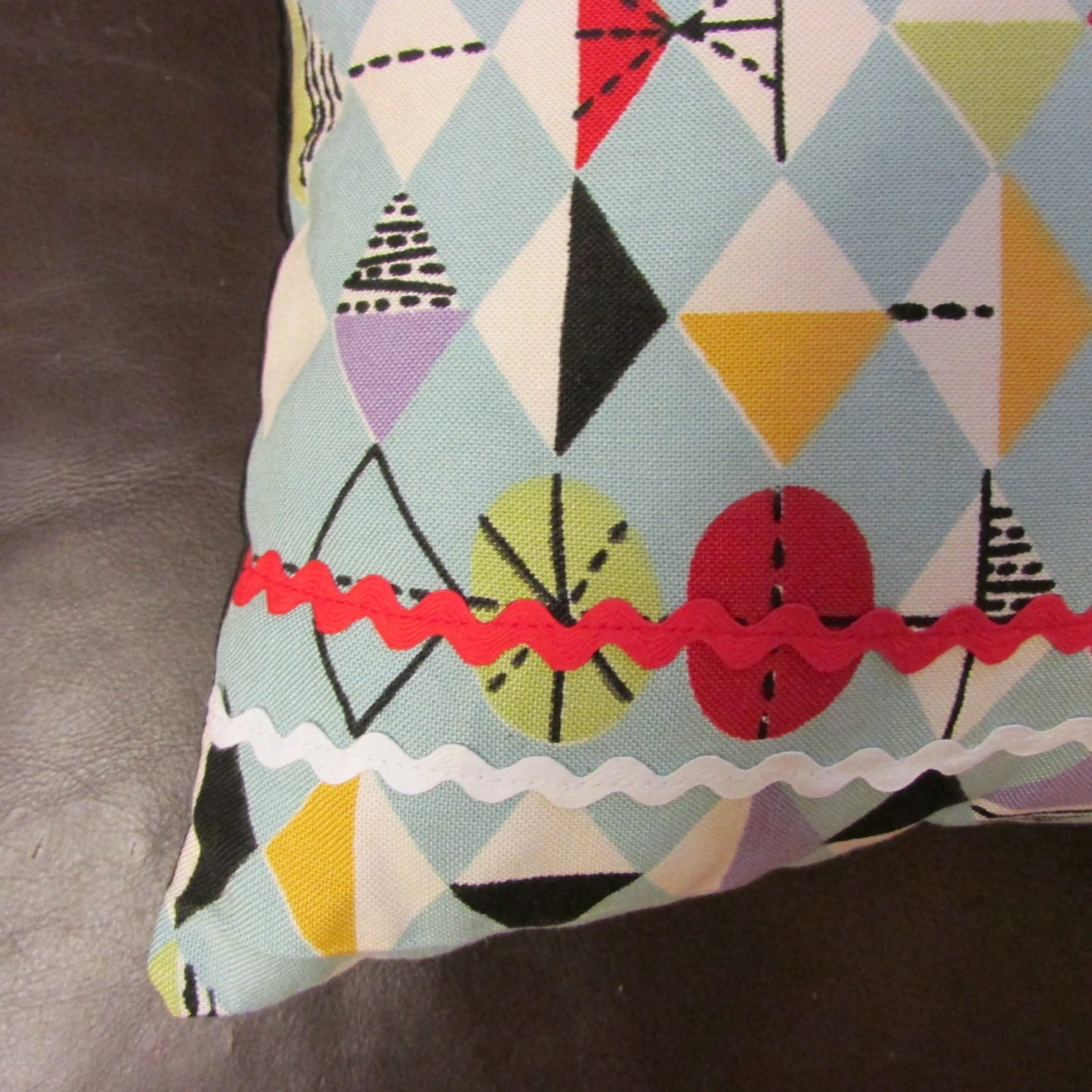 Home-made mid-century Marian Mahler atomic fabric cushion with red, & white ric-rac, and contrast black reverse