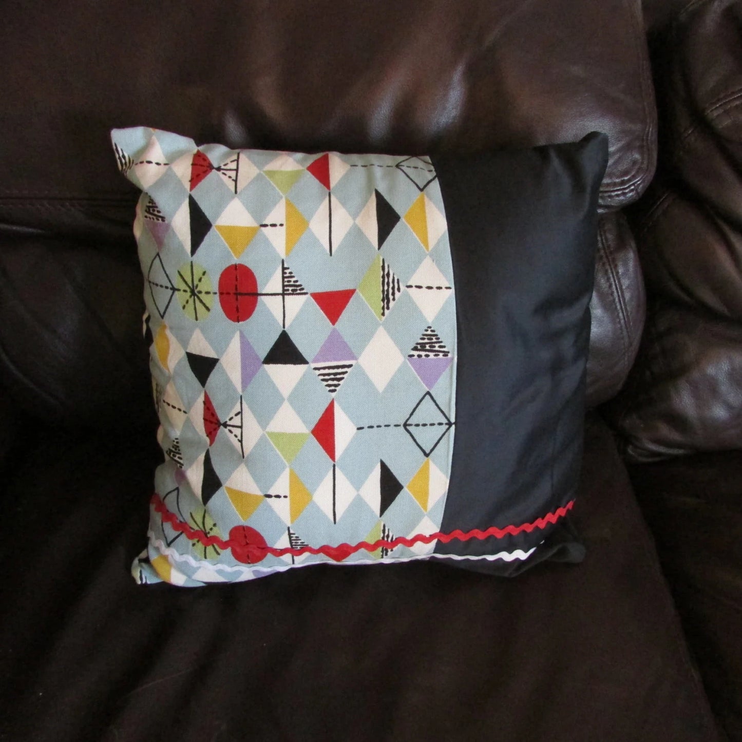Home-made mid-century Marian Mahler atomic fabric cushion with red, & white ric-rac, and contrast black reverse