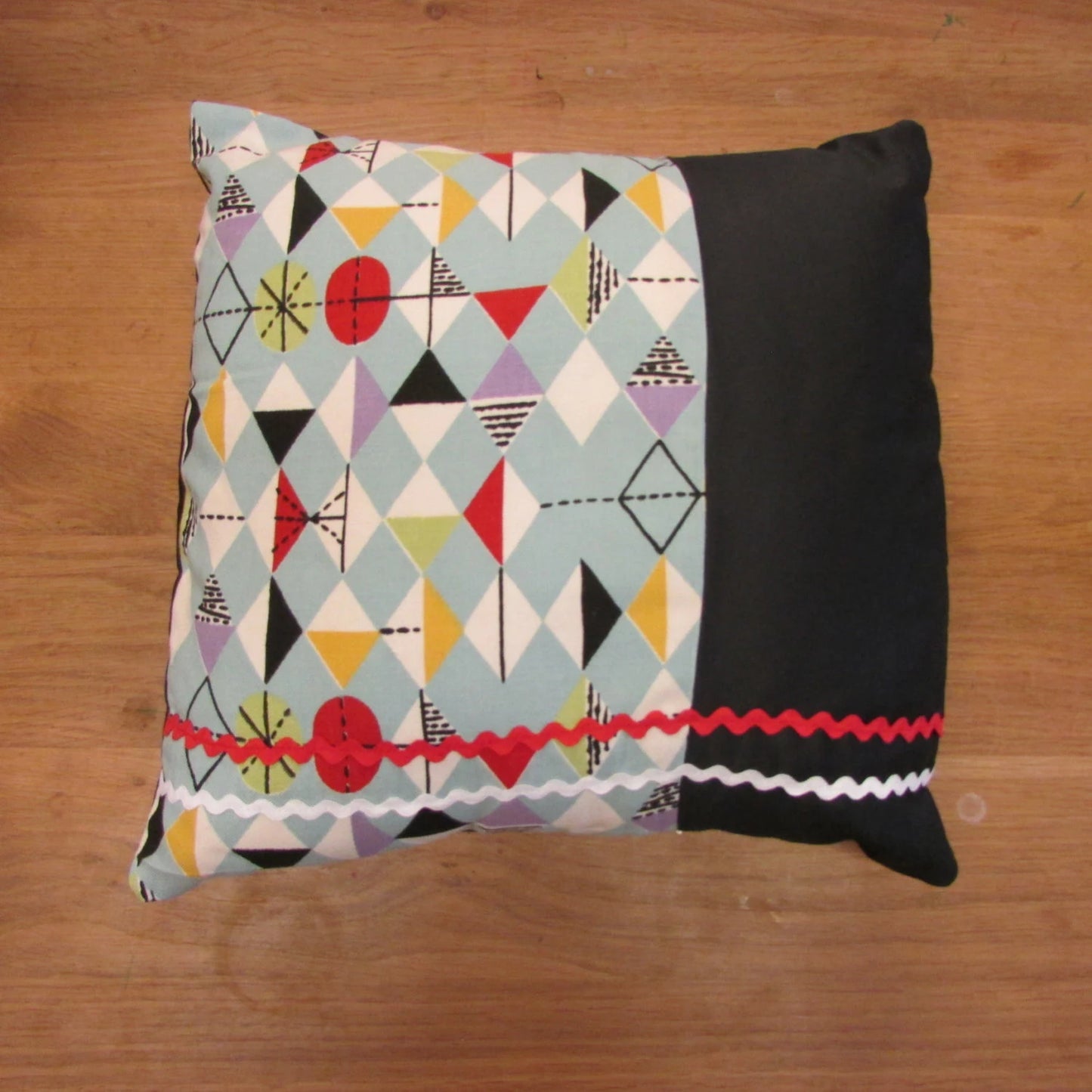 Home-made mid-century Marian Mahler atomic fabric cushion with red, & white ric-rac, and contrast black reverse