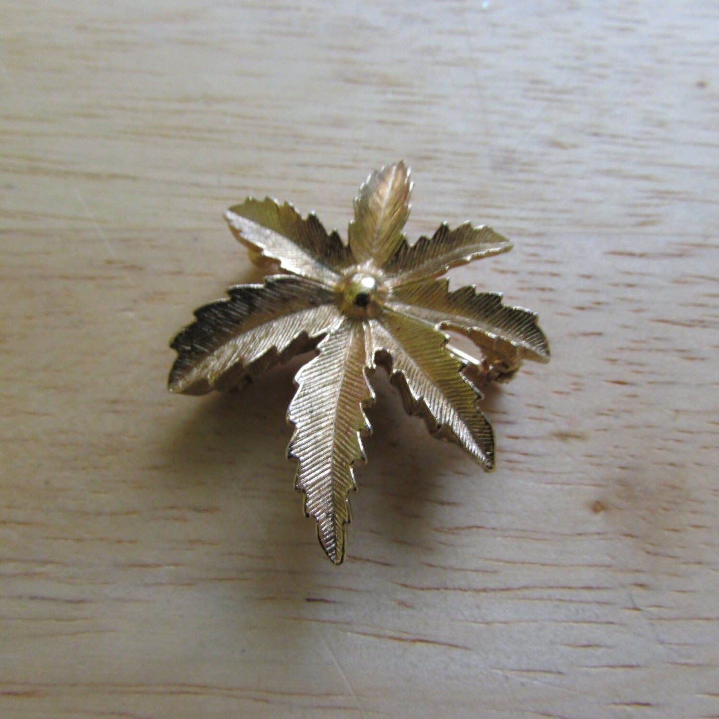 Vintage gold-tone palm frond leaf brooch, stamped CANADA