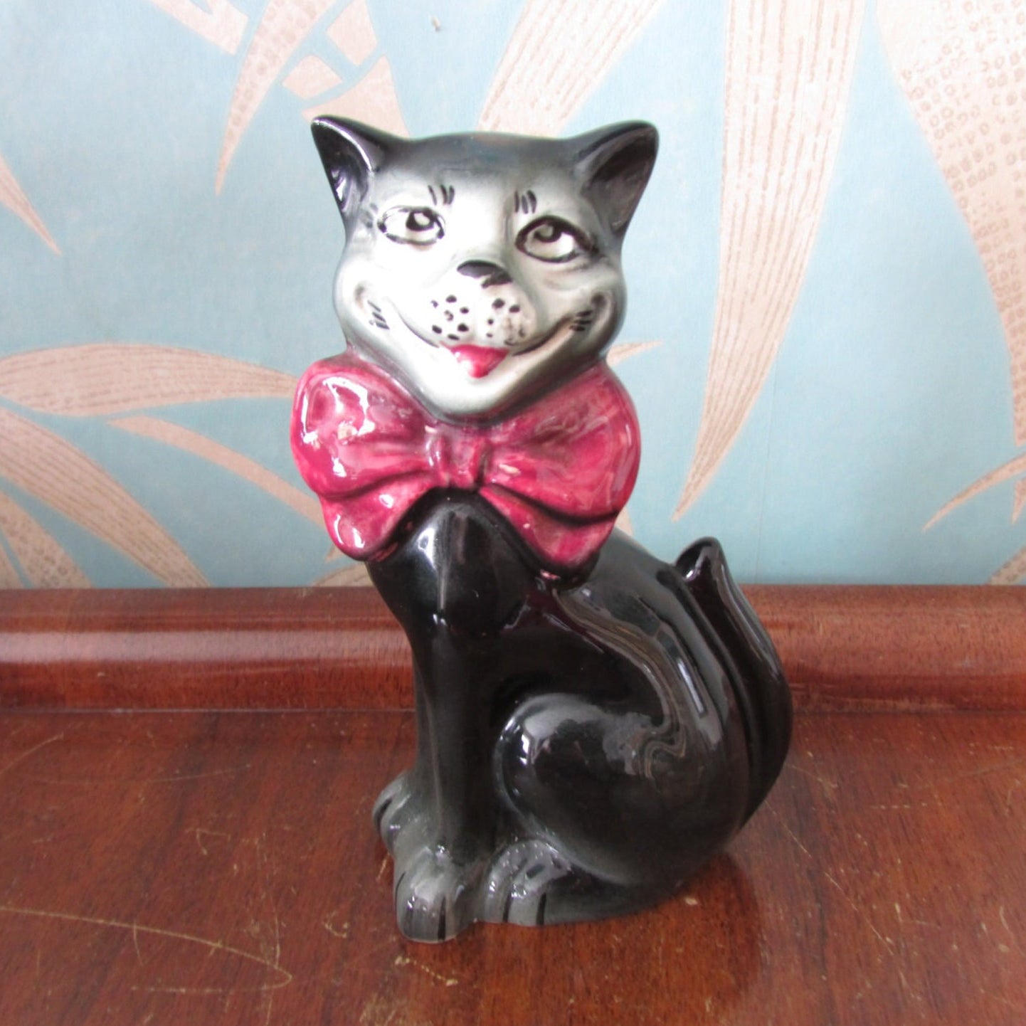 Vintage ceramic grinning black/charcoal grey cat figurine, quirky bow tie detail