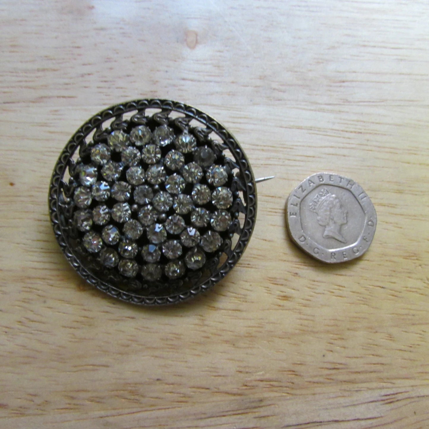 Early 20th century silver-metal diamanté fleur de lys detailed round brooch