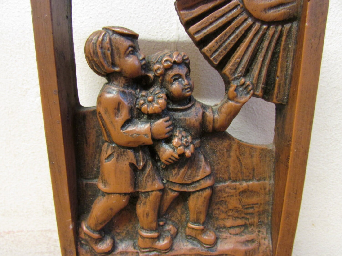 Vintage German (?) cutwork carved resin wall plaque, two children and sun