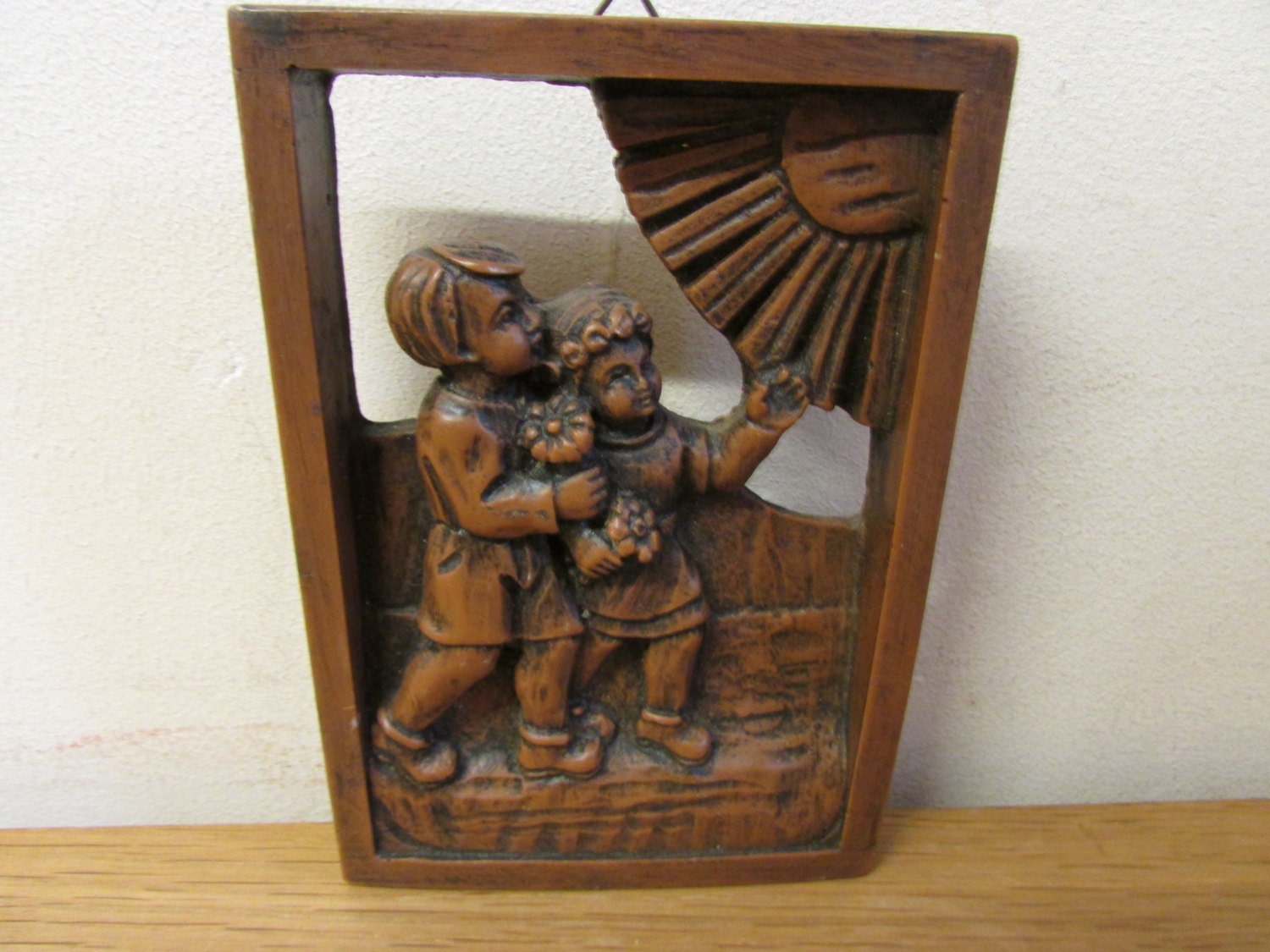 Vintage German (?) cutwork carved resin wall plaque, two children and sun