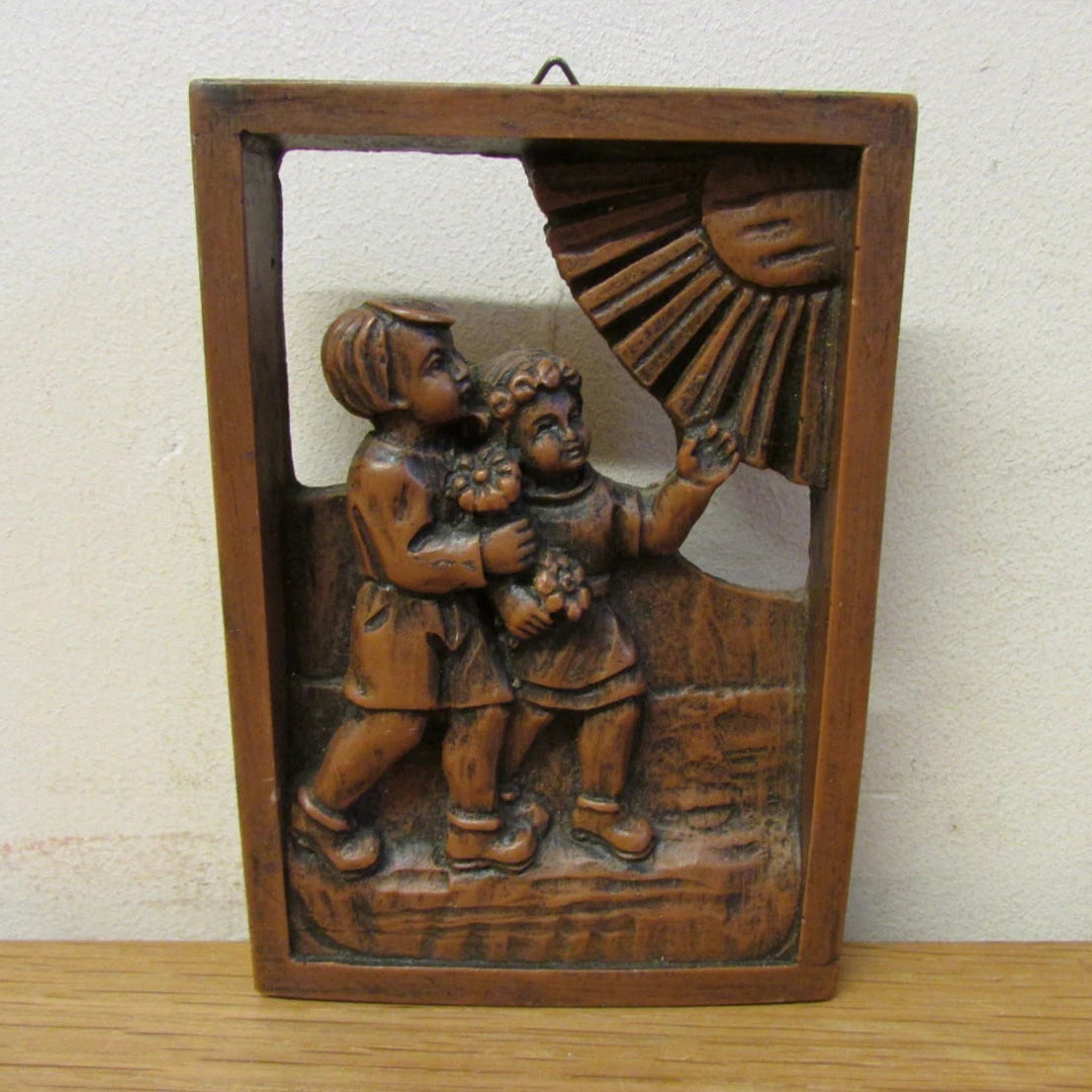 Vintage German (?) cutwork carved resin wall plaque, two children and sun