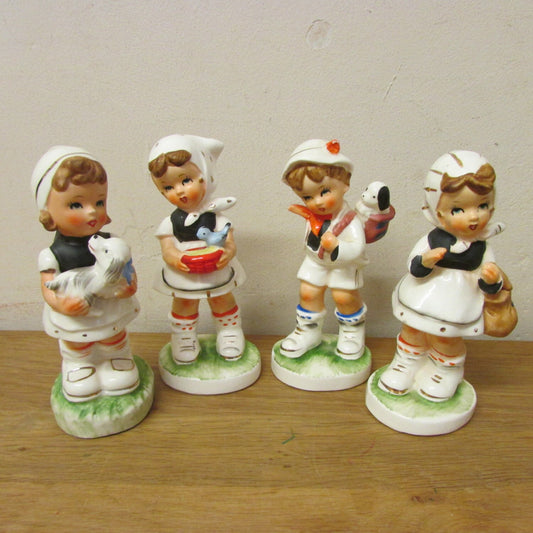 Set of four vintage Hummel-style ceramic figurines