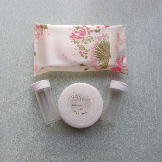 1950s/60s Celebrity New York floral travel pouch containing 2x pill vials, & collapsible drinking cup/pill box