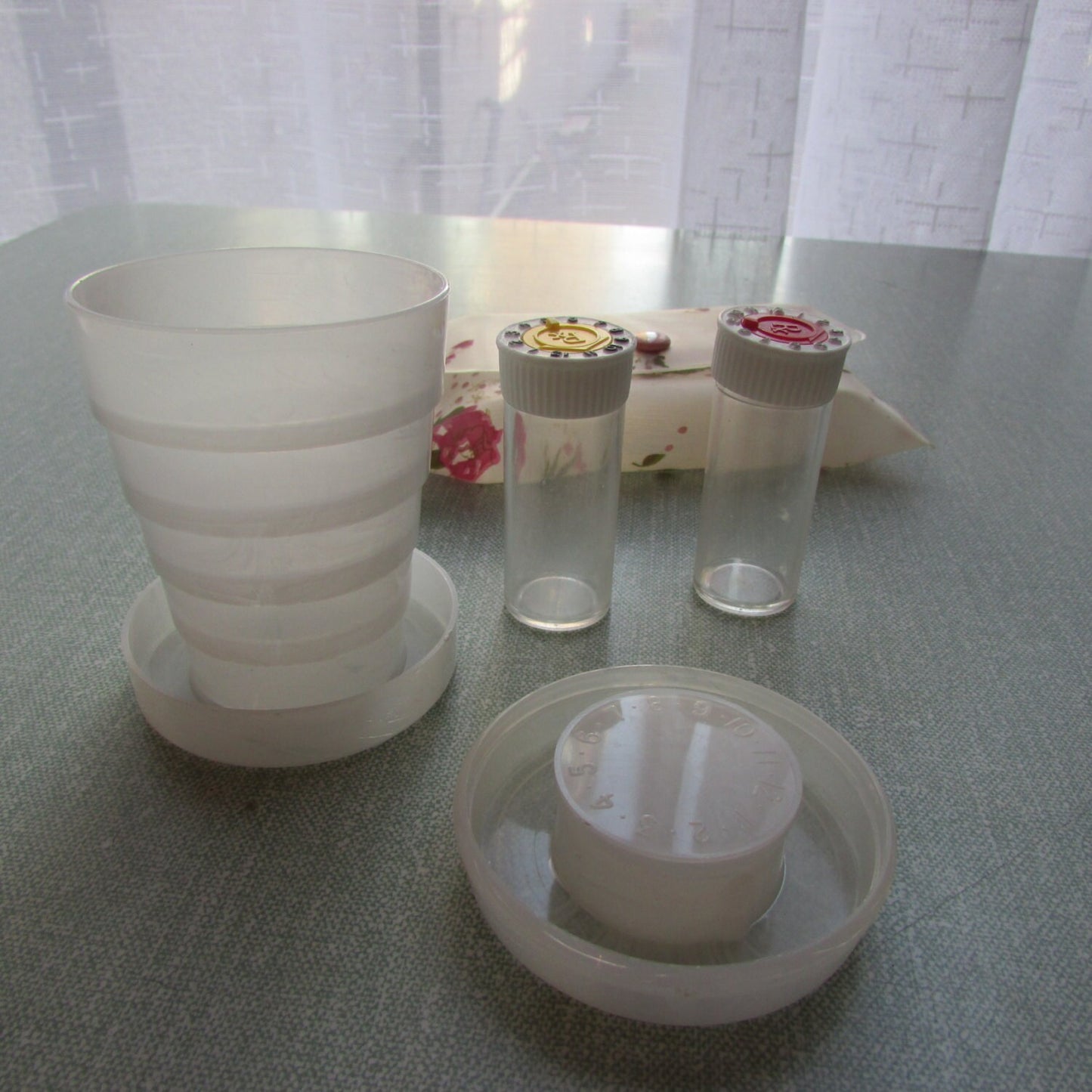 1950s/60s Celebrity New York floral travel pouch containing 2x pill vials, & collapsible drinking cup/pill box