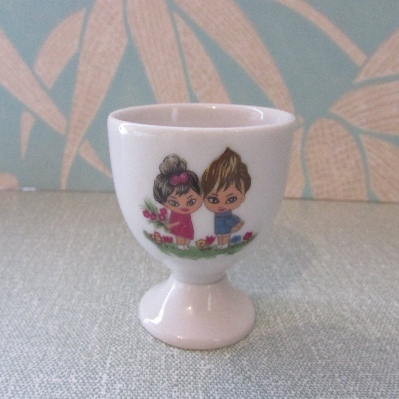 1970s retro egg cup, cute illustration of boy & girl amongst flowers