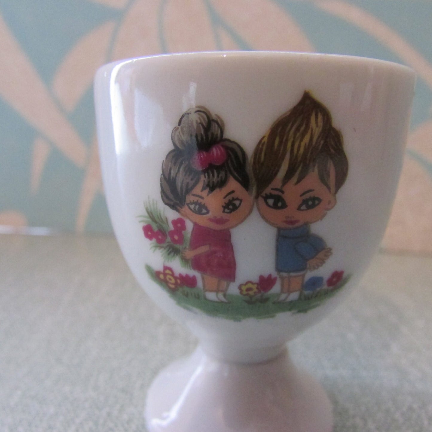 1970s retro egg cup, cute illustration of boy & girl amongst flowers