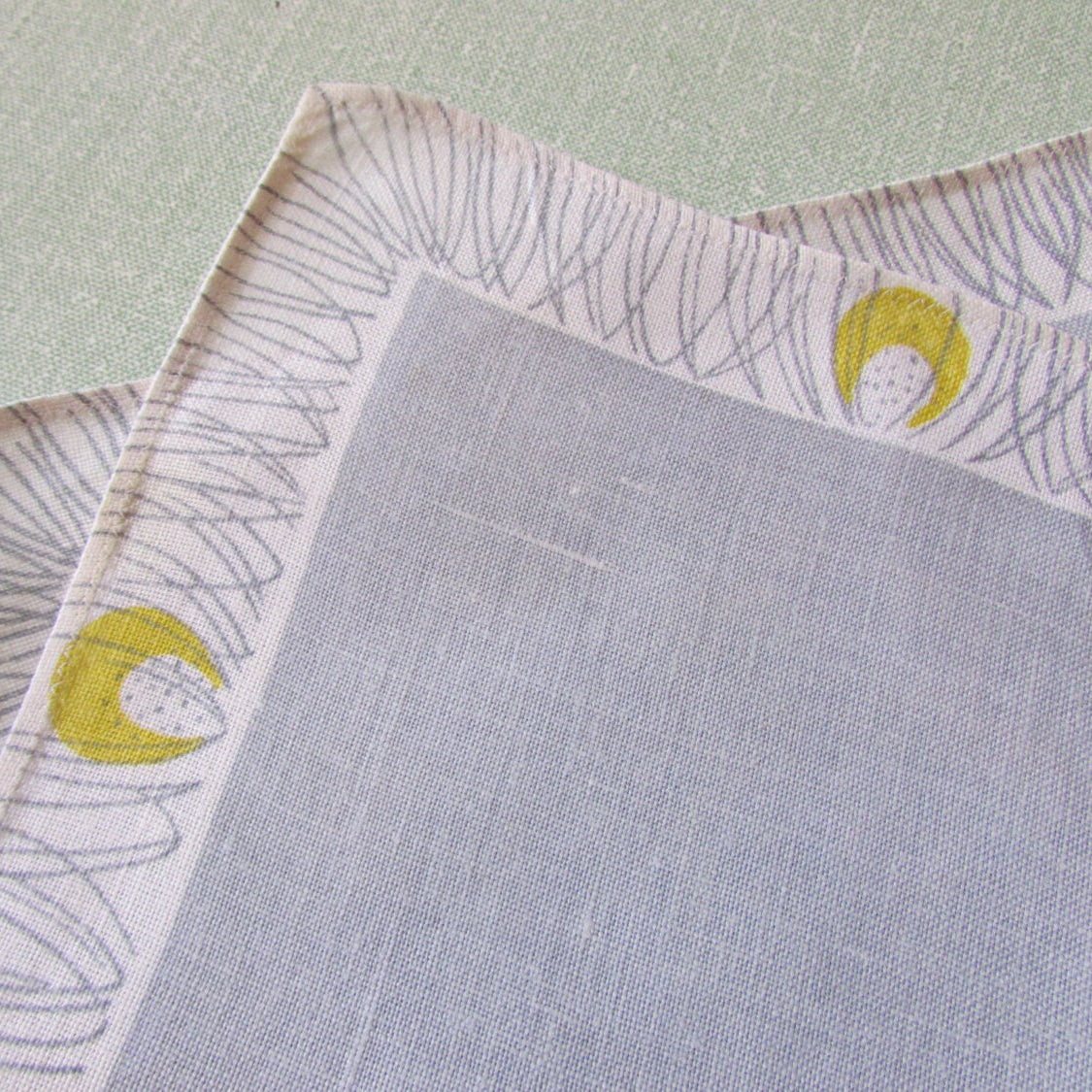 Pair of 1950s linen-like placemats, patterned border