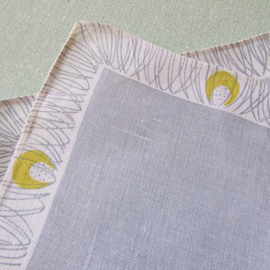 Pair of 1950s linen-like placemats, patterned border