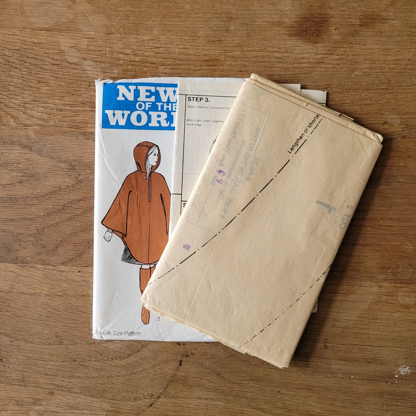 Uncut 1970s News of The World No.83 sewing pattern for hooded poncho, sizes 3/4 years to 9/10 years (complete)